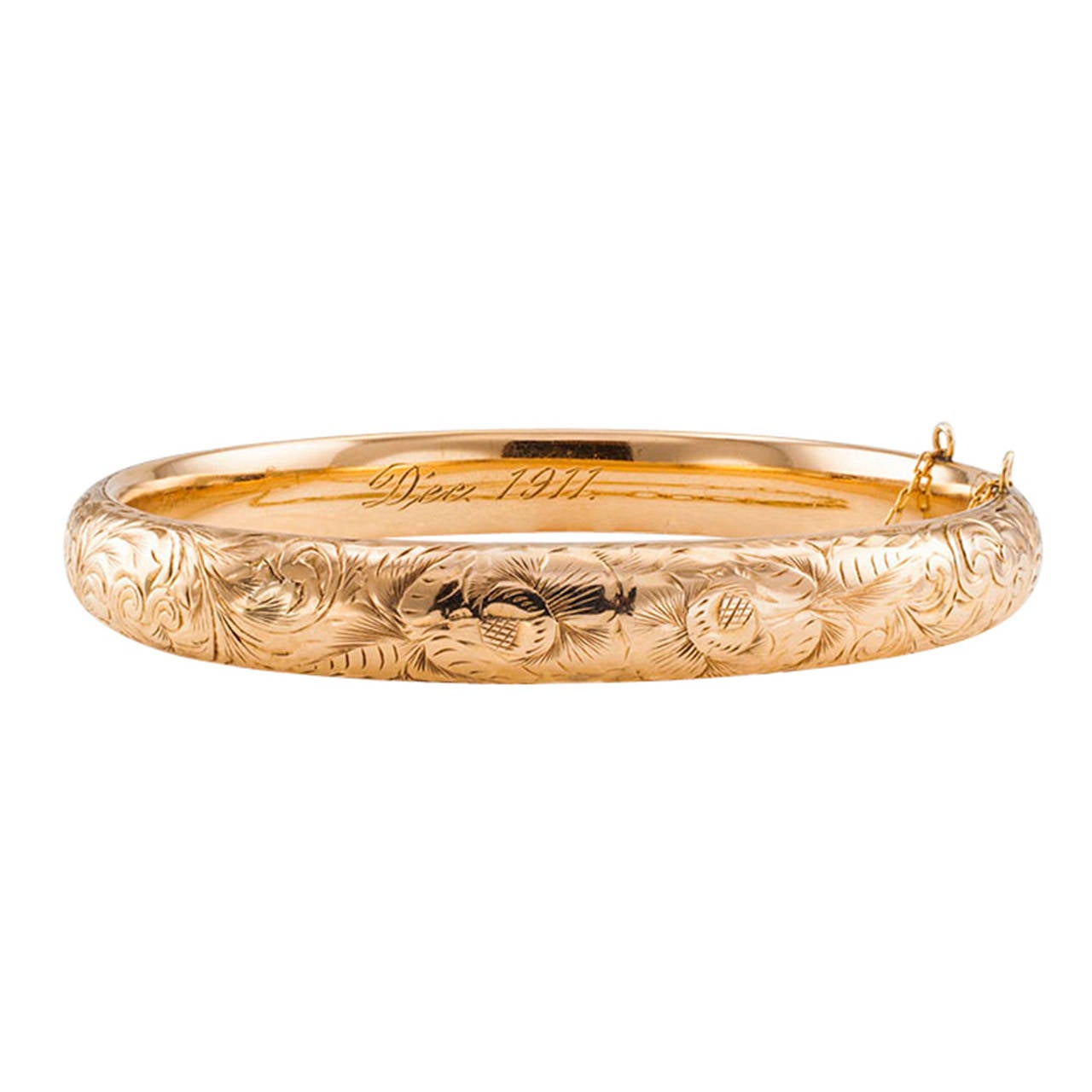 Engraved Antique Gold Bangle Dated 1911

Continuously engraved  with romantic floral motifs, typical of the period, that remain rich and crisp,  the slightly domed hinged bangle resembles a ribbon of flowers, signed WAB for Wordley Alsop and