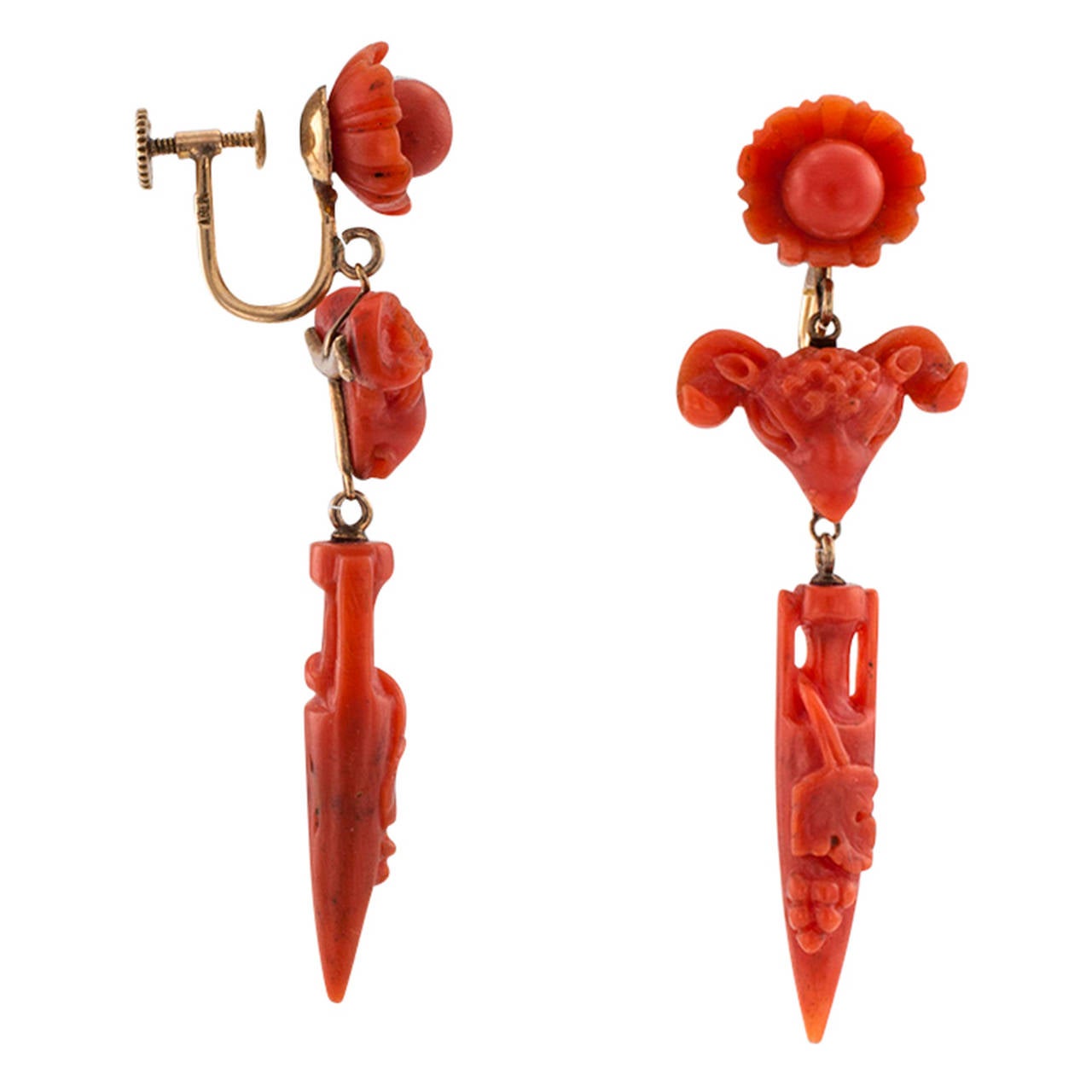 Carved Coral Victorian Archaeological Revival Pendent Earrings

The articulated designs are a composition derived from three distinct, richly carved,  red coral components.  The surmounts are shaped as a pearl in a clam shell, connected to ram's