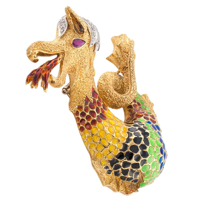 Possibly a Frascarolo design, the whimsical dragon's body of textured 18 karat gold, decorated with multicolored enamel scales, curly diamond locks, ruby-set eye... looks way too friendly for someone who is breathing fire!  A larger scale brooch