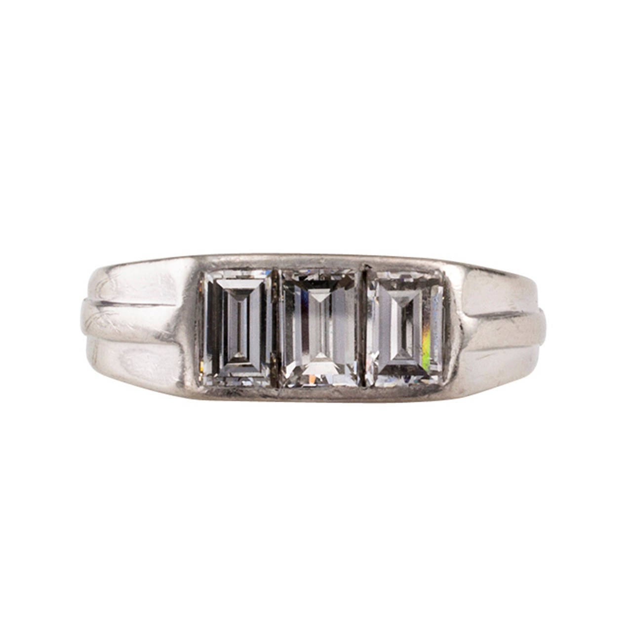Art Deco Baguette Diamond And Platinum Ring Band

Ingeniously designed with a simple play on geometric lines to showcase the three fine and large rectangular baguette diamonds totaling  approximately 1.50 carats, approximately F - G color and VS