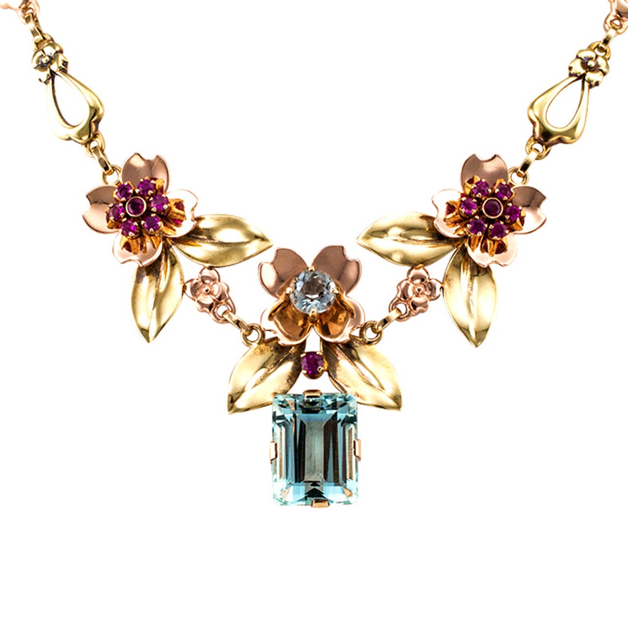 Aquamarine And Ruby Pink And Green Gold Retro Necklace

Sweet and lovely never looked as self assured and feminine as they do in this beautiful example of Retro jewelry.  The designer achieves maximum impact by using alternating elements of green