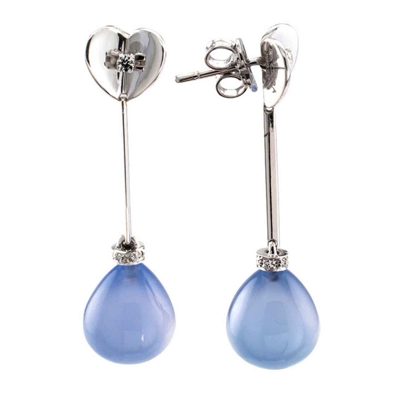 Escada Blue Chalcedony And Diamond Swinging Earrings

Whimsical and fashionable, the blue chalcedony teardrops feature diamond-set caps, connected with knife edge links to the heart-shaped surmounts, like a mirrored open book.  In the center of