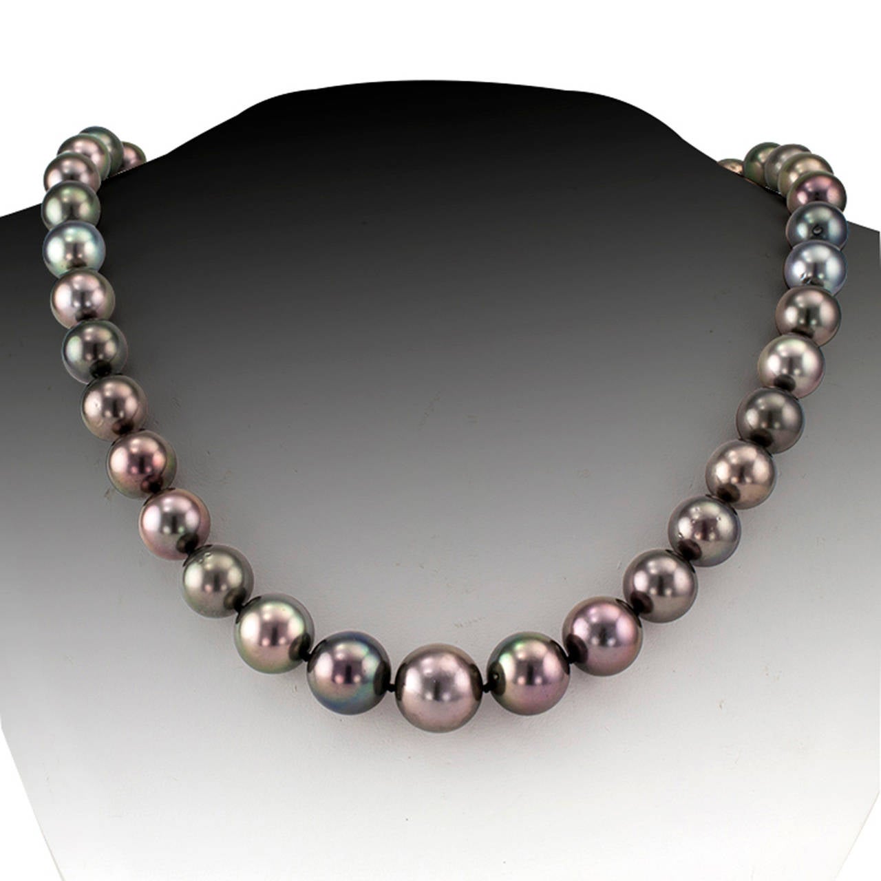 Black Tahitian Cultured Pearl Necklace

Comprising of 39 black Tahitian cultured pearls measuring from 10.0 to 13.84 mm terminating in a 14 karat gold spherical clasp pave-set with diamonds totaling approximately 2.00 carats, approximately 19