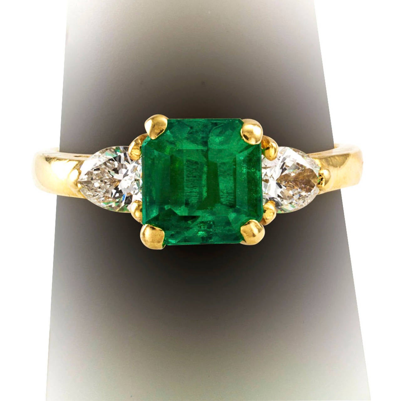 Estate Emerald-Cut Emerald and Pear-Shaped Diamond Ring

This ring has nothing to be shy about.  It is neither too big nor too small.  The diamonds are there to highlight the emerald, which is clean and vibrant in color.  Two outstanding qualities