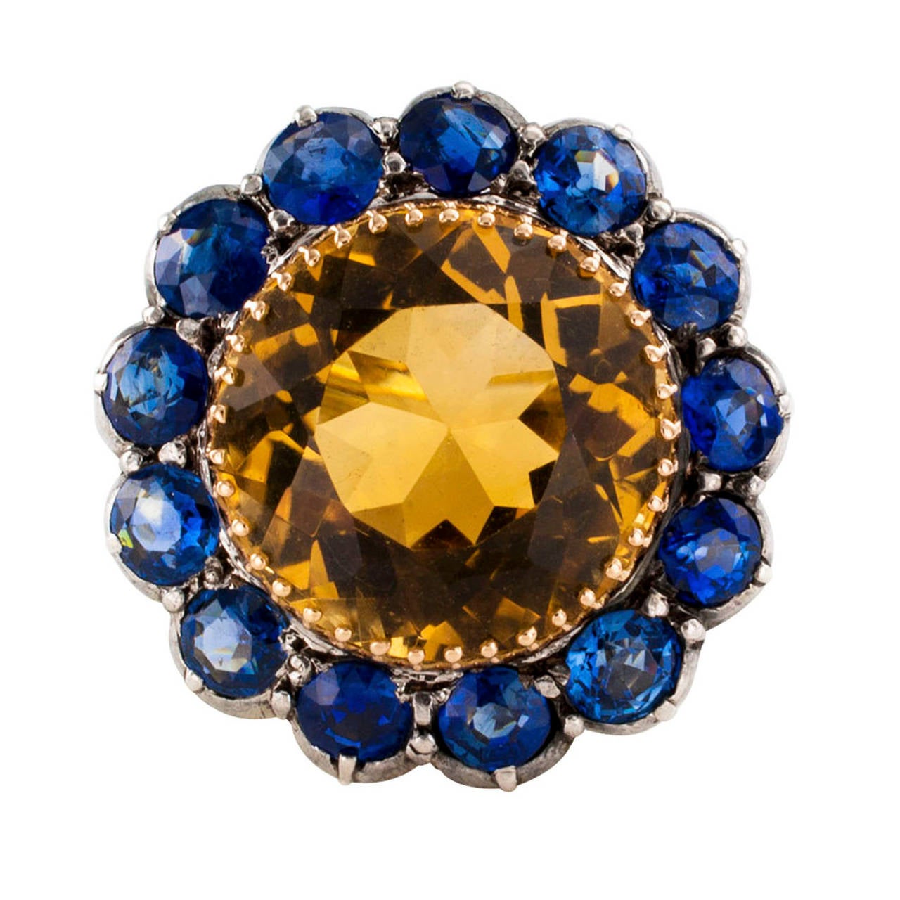 Antique Citrine and Sapphire Large Scale Cocktail Ring

If you enjoy wearing a large and unique ring, consider this one, with its striking color combination.  Doing a circle dance around the spectacular round citrine, the thirteen bright blue