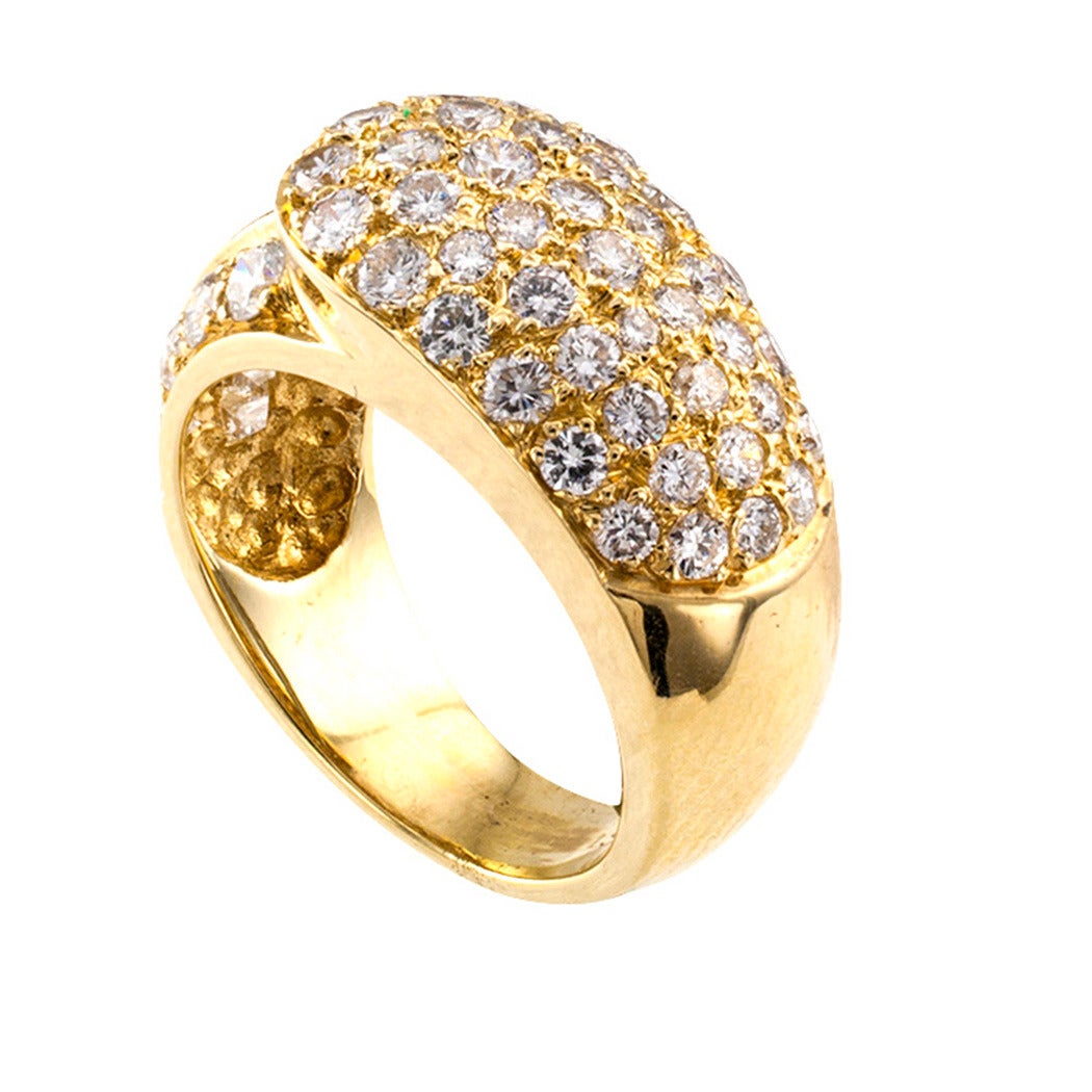 Pave Diamonds And Gold Buckle Ring

The design takes an abstract approach to a popular ring style, the buckle.  Fifty-four baguette and round brilliant-cut diamonds totaling approximately 2.25 carats, approximately G - H color and VS clarity, play