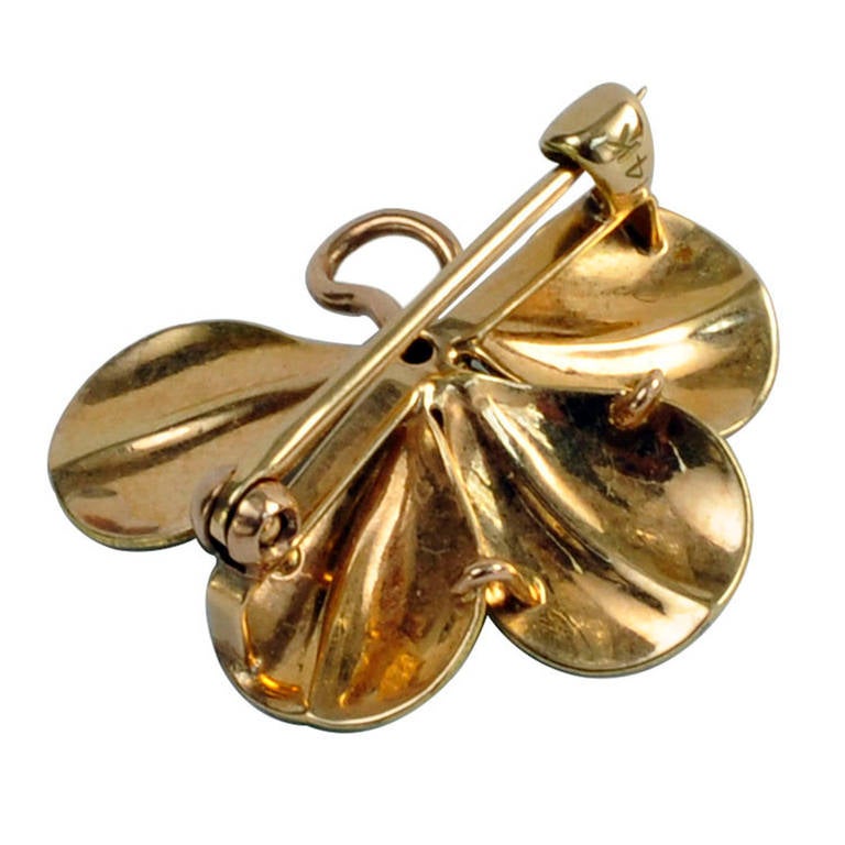 This Enamel Art Nouveau Four-Leaf Clover Brooch, Circa 1905,  looks so real...  With a  claw-set old-mine cut diamond weighing approximately 0.05 carat. In 14kt gold.  Approximately 1 inch by 3/4 inch overall.