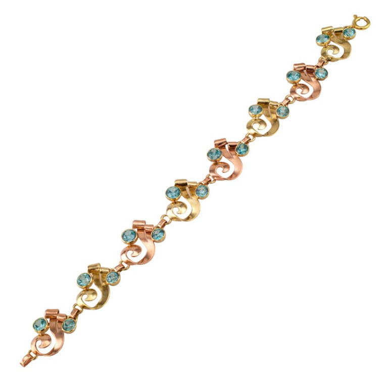 Vintage Zircon and Two Tone Gold Retro Bracelet

 This unique hand-made estate bracelet features an eye catching combination of alternating green and pink 14Kt gold links contrasted with really beautiful bezel-set blue zircons, making it as yummy,