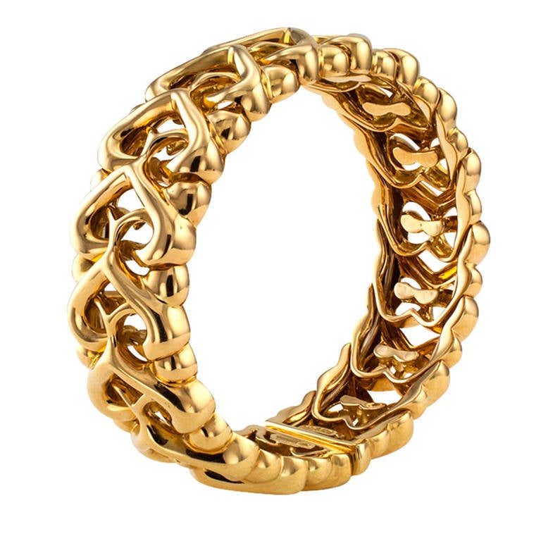 This Bulgari openwork designed cuff bracelet composed by a series of interlocking heart-shaped motifs, is a very fine example of a high quality estate jewelry, which is very wearable.  17 mm. wide, signed Bulgari, in 18 karat gold.