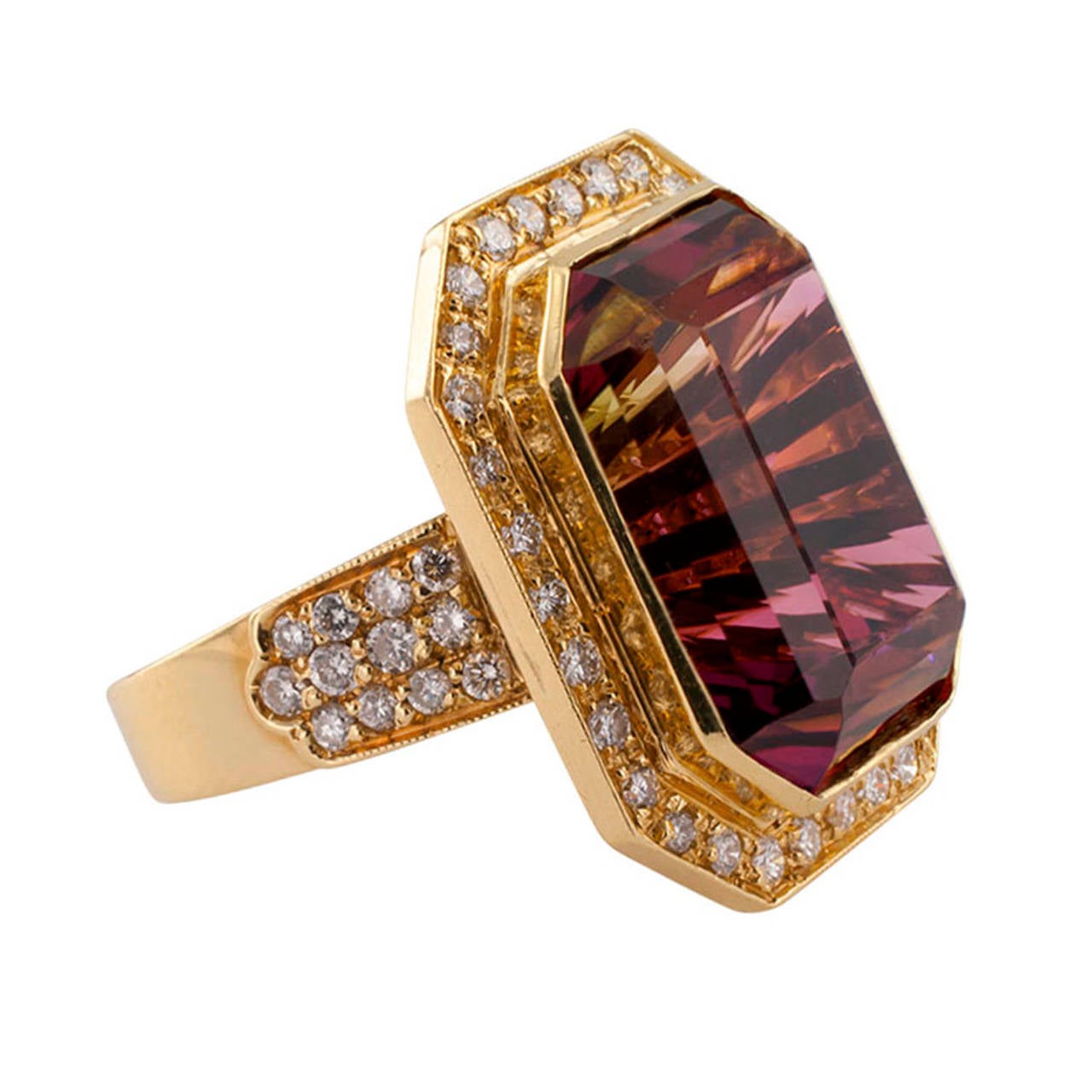 One of Webster's dictionary definitions for fascinate is: to attract by delightful qualities.  Depending on the angle from which it is viewed, this emerald-cut bi-color tourmaline weighing approximately 27.50 carats displays a fascinating and