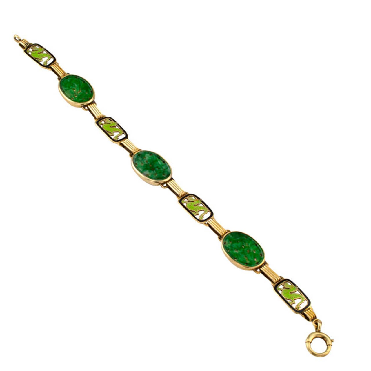 Carved Jadeite Art Deco Bracelet
Circa 1930, featuring three carved oval green jadeite bezel-set panels with very pretty and pleasing color, connected by elongated geometric links between a larger openwork panel accented with a ferocious green