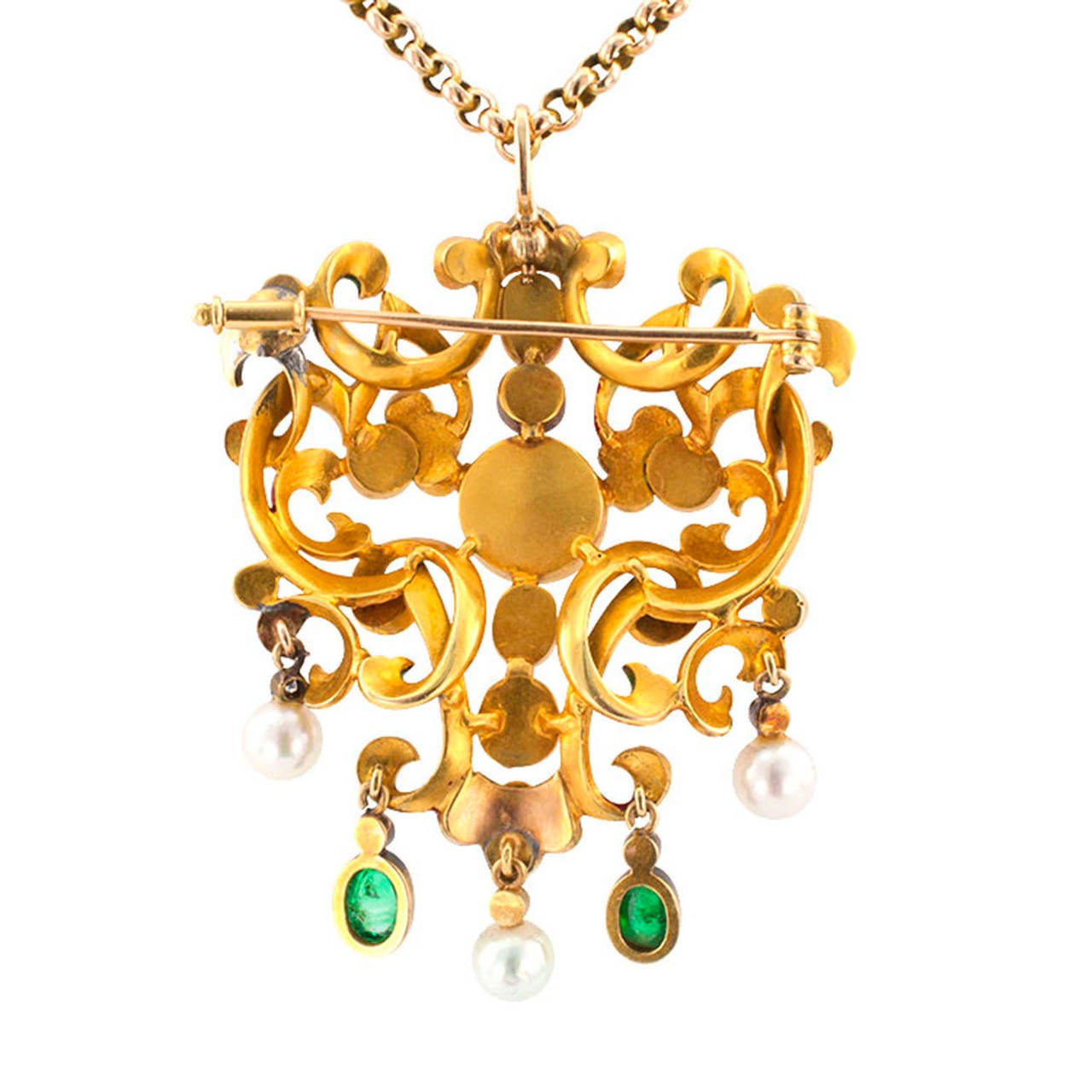 Circa 1890, bordering on the realm of dreams, a kaleidoscope of luminous gems, sparkling diamonds and brightly colored enamel, the open work design centers upon an old blister pearl within a network of interlaced ribbon motifs applied with bright