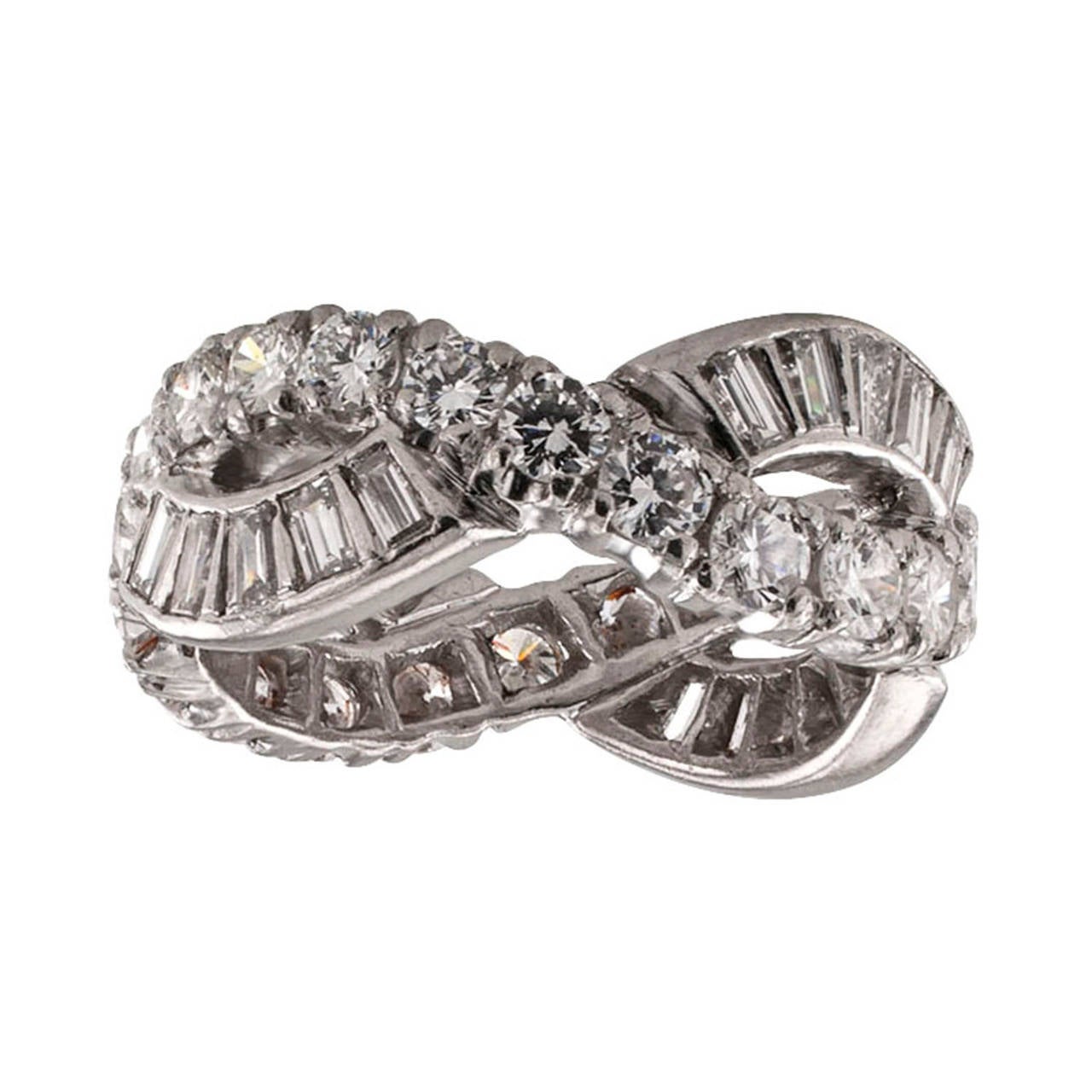 2.75 Carats Wide Eternity Diamond Platinum Ring

A great diamond eternity band, circa 1950.  The design composed of a curved  course of round brilliant-cut diamonds entwined with a course of baguette diamonds, the forty-four diamonds totaling