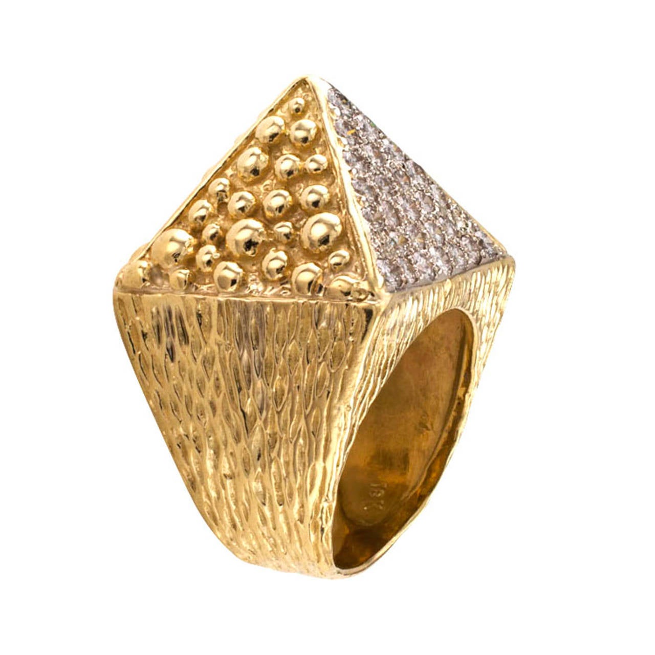 A unique diamond ring, circa 1970, bold and mystical... carry the force with you... designed as a four-sided square pyramid, three of its sides covered with gold beads of varying sizes, the fourth side pave-set with round brilliant-cut diamonds