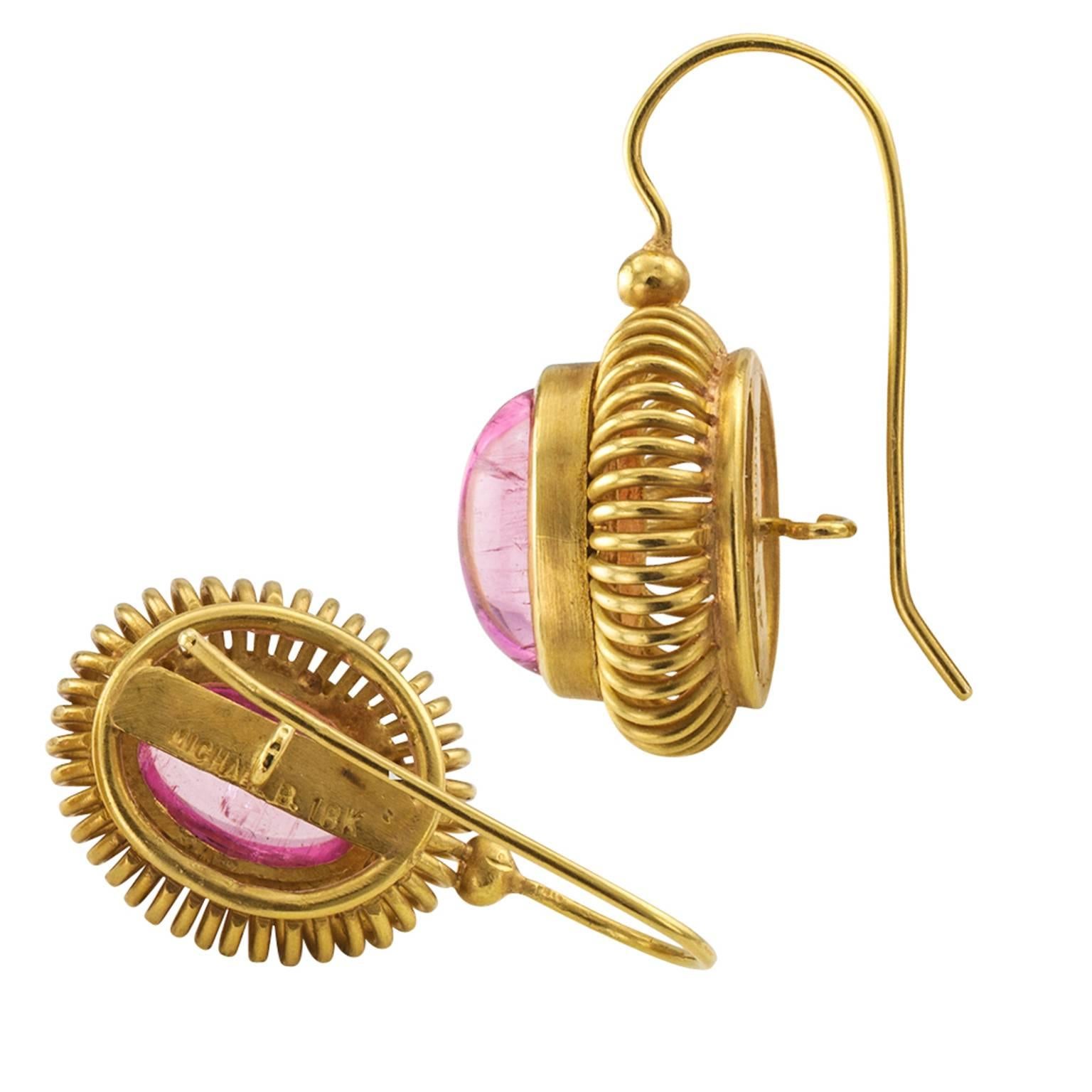 Pink Tourmaline Contemporary Estate Earrings

A different look, cheerful, feminine and modern.  Luscious  cabochon pink tourmalines offset with ringlets of rich matte gold.  Contemporary, but timeless simple elegance.  Funky enough to wear with