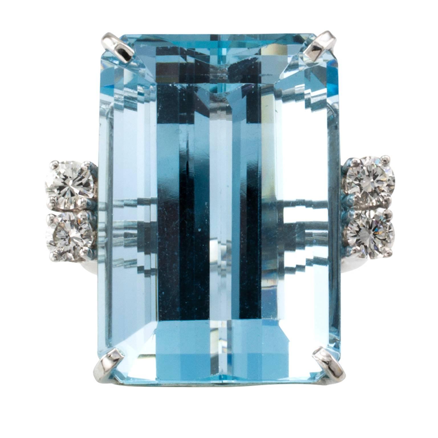 30.00 Carats Aquamarine and Diamond Cocktail Ring Circa 1950

Approximately 30.00 carats packed into a dramatic emerald cut aquamarine with beautiful blue color and brilliance.  Mounted in 14 karat white gold in a design embellished with four