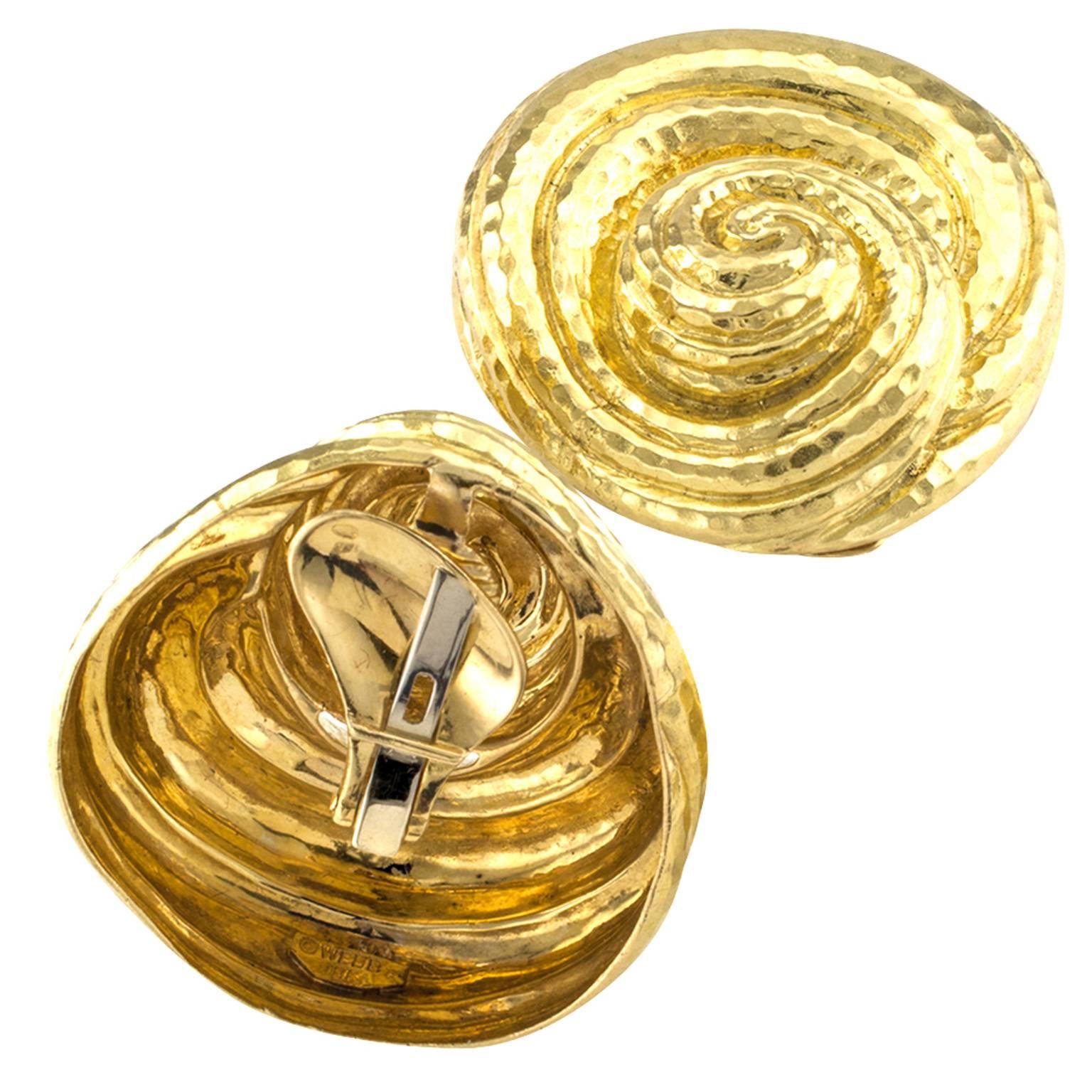 David Webb Estate Hammered Gold Earrings

These are definitely WOW, WOW, WOW  great earrings by David Webb.  Measuring approximately 1 5/8  by 1 7/16 inches overall, they will get noticed!  Elegant, sophisticated, forever fashionable and delicious