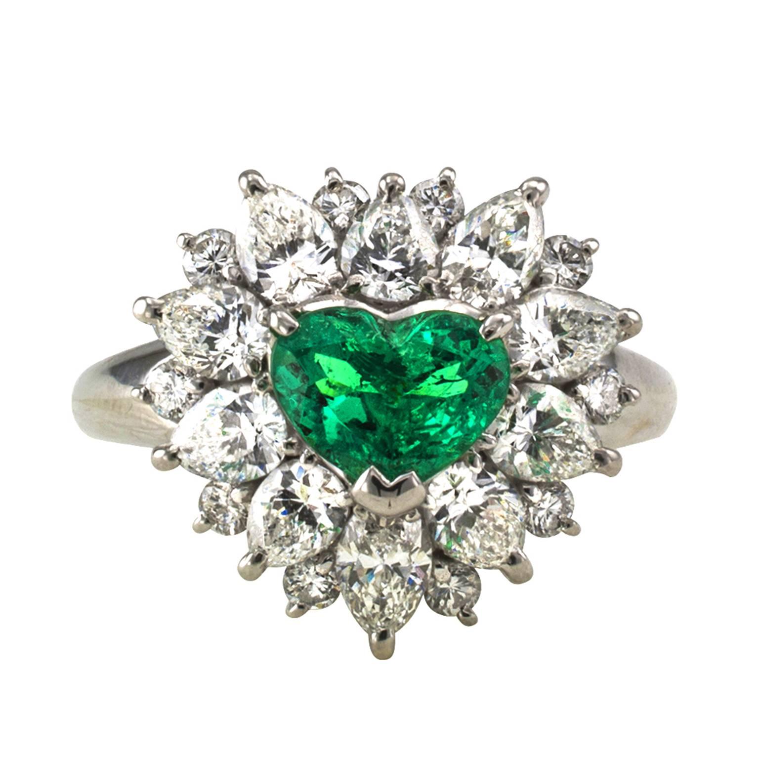 Heart-Shaped Emerald and Diamond Cluster Ring

Cluster rings can be found in many denominations, but one as special as this is a rare find, centering upon a very fine heart-shaped emerald weighing 0.80 carat, within a stepped border comprising