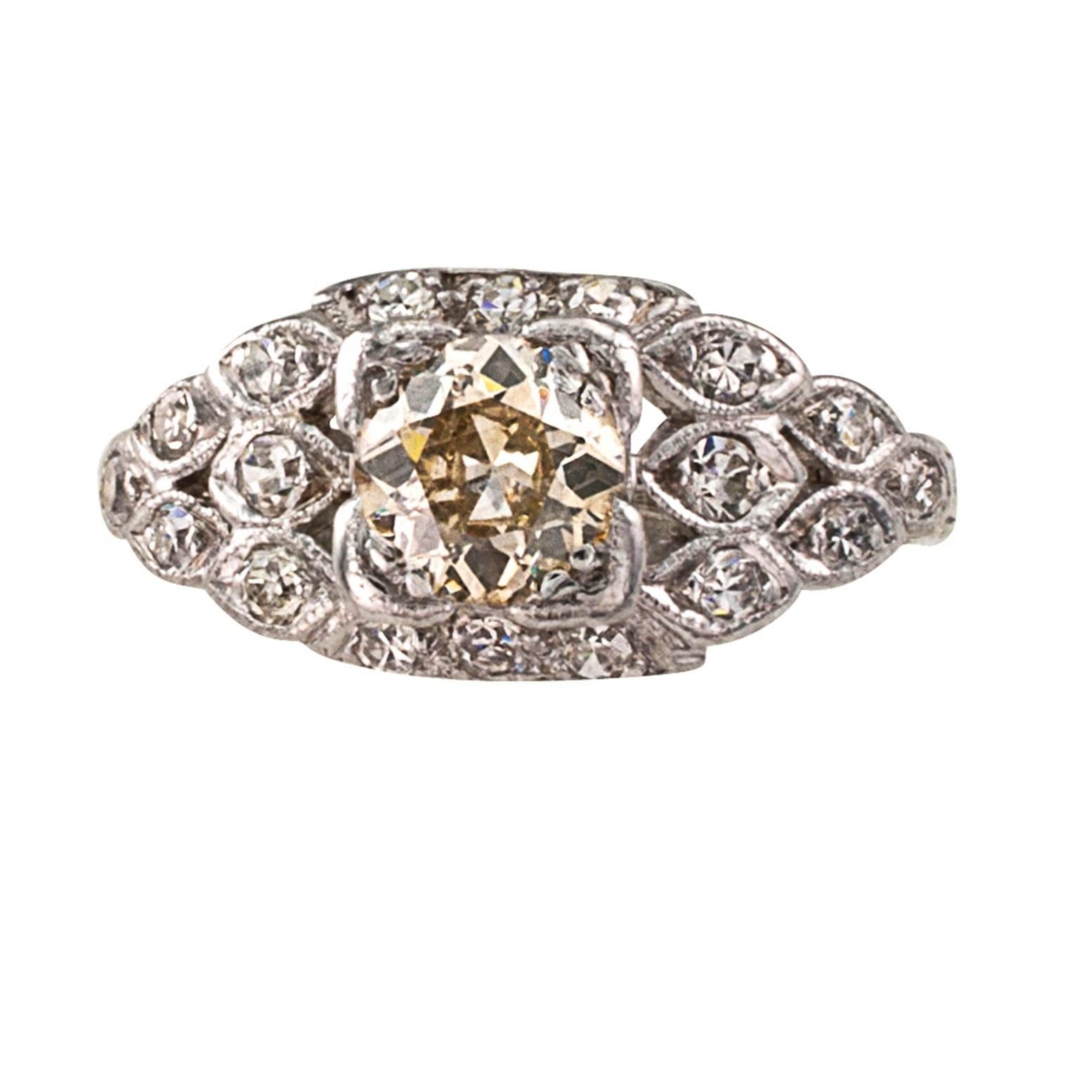 .65 Carat Yellow-brown Old European-cut Diamond Ring

Natural color diamonds are so special,  so different.  In an Art Deco mount, such as this, where eighteen smaller round white diamonds accentuate the color difference between themselves and the