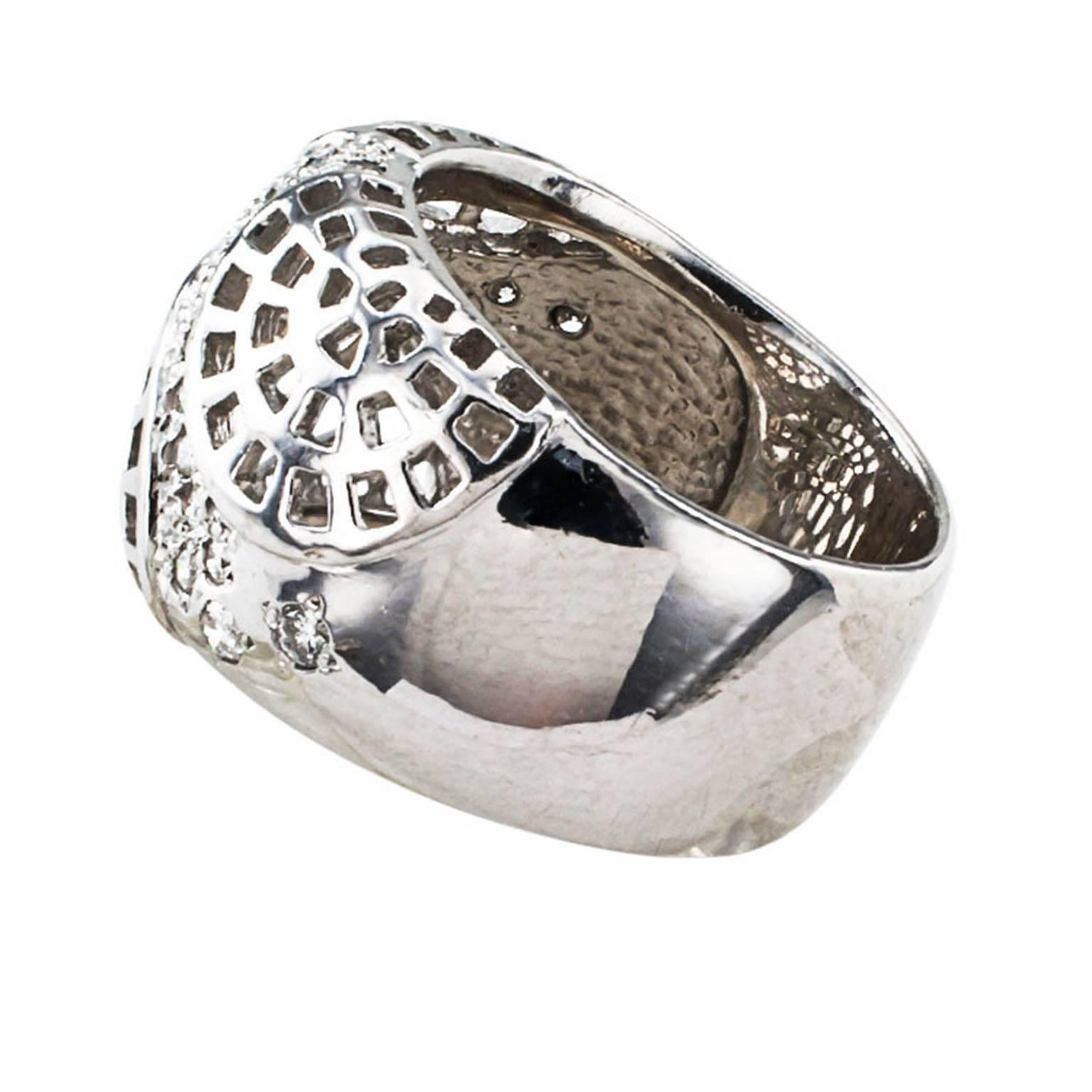 Futuristic Platinum and Diamond Wide Ring Band

It is different, makes a statement, with futuristic and abstract graduating semicircular honeycomb like motifs connected via a plane pave-set with round brilliant-cut diamonds decorate the top