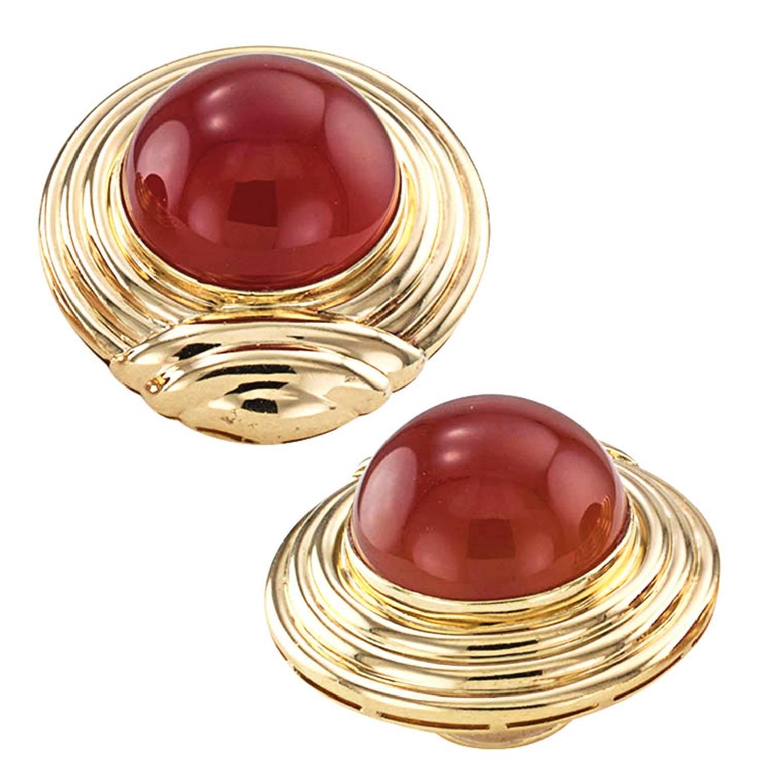 Carnelian and 18 Karat Gold Ear Clips

Tailored statement-maker 18 karat yellow gold earrings, showcasing a pair of outstanding carnelian cabochons that glow like honey in a jar, framed by stepped fluid gold lines that catch and reflect light in a