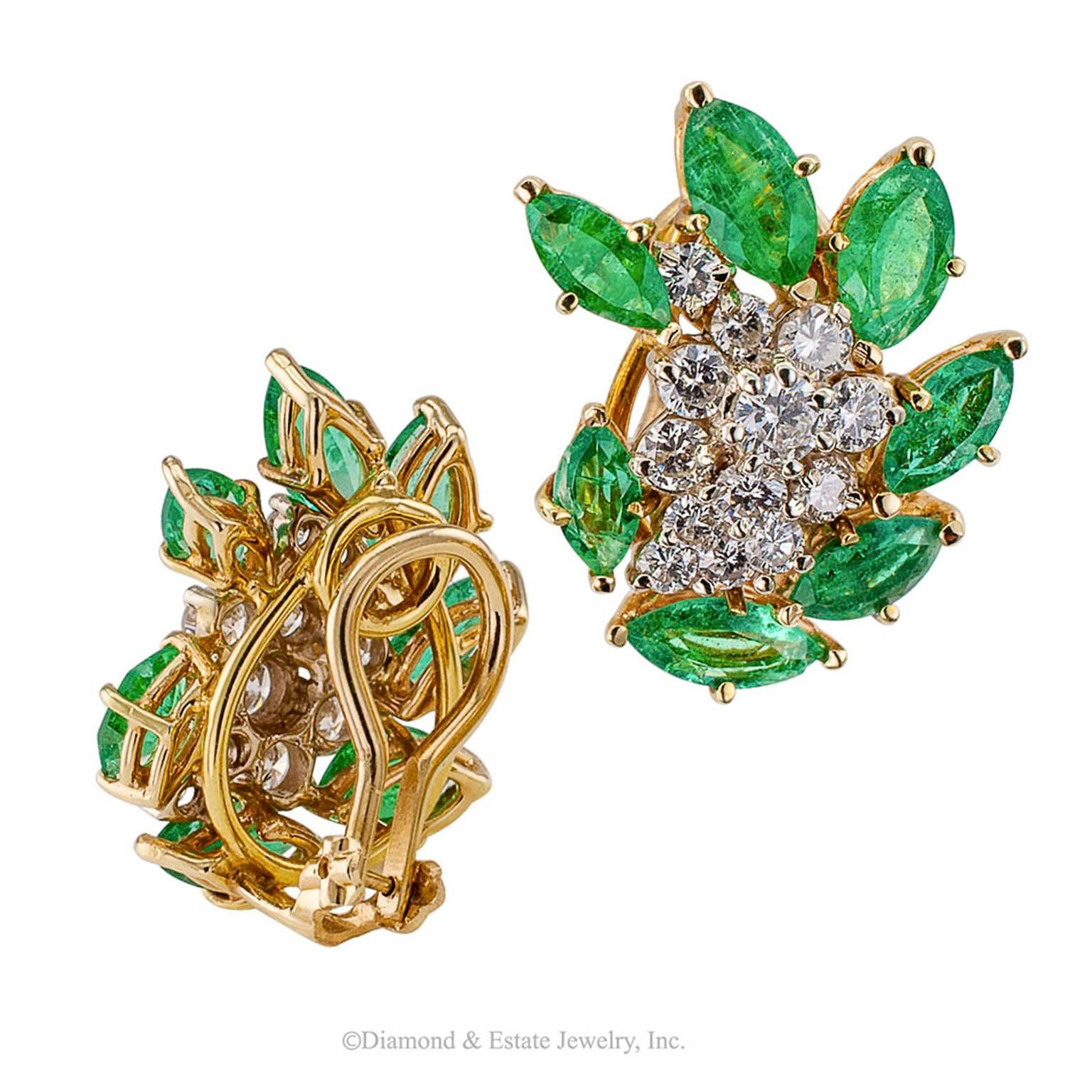 1970s Emerald Diamond Gold Ear Clips

1970s emerald and diamond  gold ear clips.  Designed as a cascading cluster of round brilliant-cut diamonds weighing approximately 1.50 carats, approximately H color and SI clarity, within a radiating border of