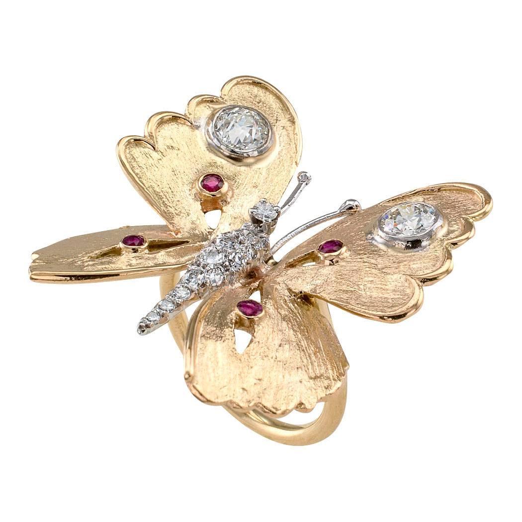 1970s Butterfly Gold Ring

1970s butterfly gold ring set with rubies and diamonds.  Designed to sit perfectly poised on your finger, a magical jewel of incredible character and beauty with golden wings that thanks to a hand applied texture, glisten