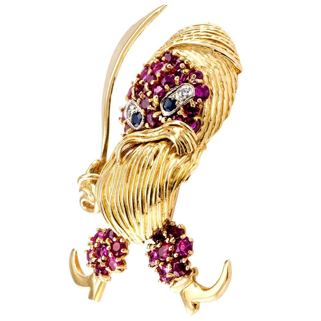 1960s Pirate Ruby Diamond Sapphire Gold Brooch

1960s Pirate gold brooch with  rubies sapphires and diamonds.  A very whimsical swashbuckling warrior with a mean look on his face, swinging high his Scimitar, ready for adventure and excitement. 