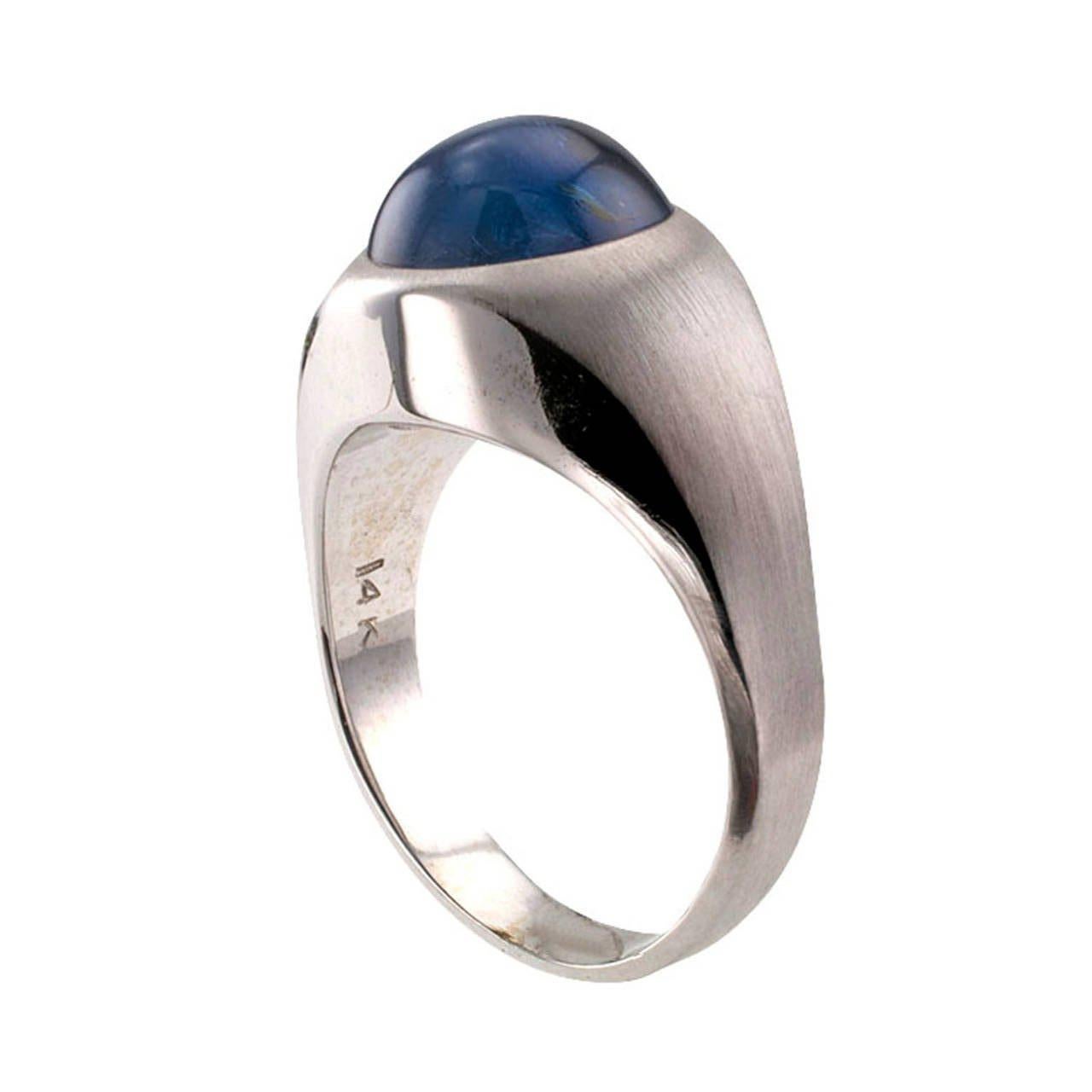 Circa 1950's, this blue star sapphire is mounted in a classical designed ring.  Featuring a translucent blue star sapphire (approximately 9-10 carats) displaying a well defined star, bezel-set in a 14 karat white gold mount with contrasting