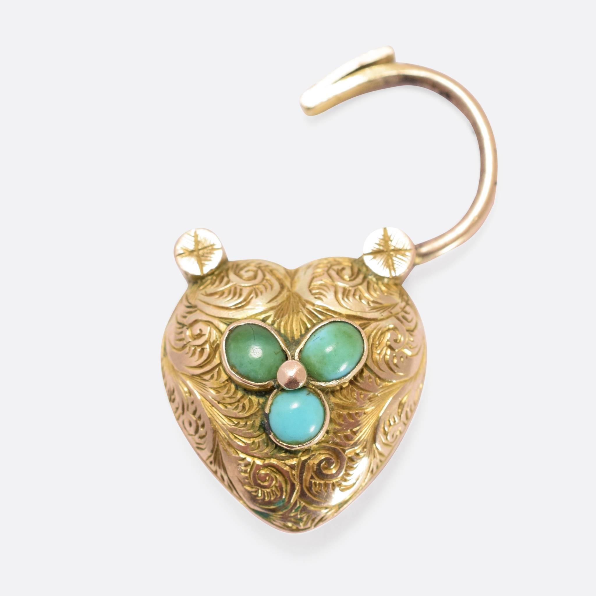 This beautiful antique bracelet features a fine fancy link chain, and a rather special locket clasp. Set with three turquoise cabochons, the clasp is shaped like a heart padlock, with a locket compartment to the back, and pretty hand-chased detail