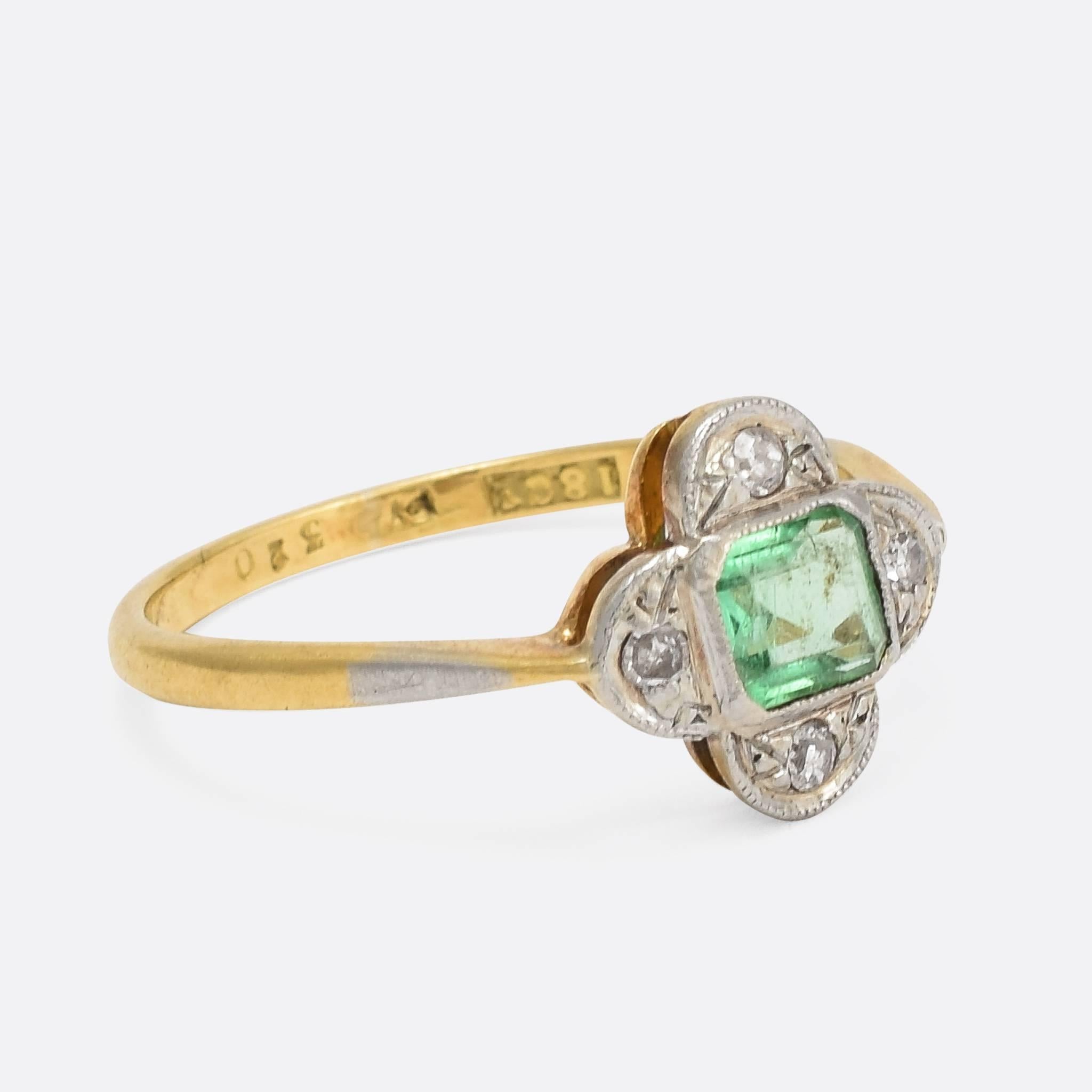 This stylish emerald and diamond cluster ring dates to the early Art Deco period, c.1920. It's modelled in 18ct yellow gold and platinum, with an attractive quatrefoil head finished in fine millegrain detail. The natural emerald is of a particularly
