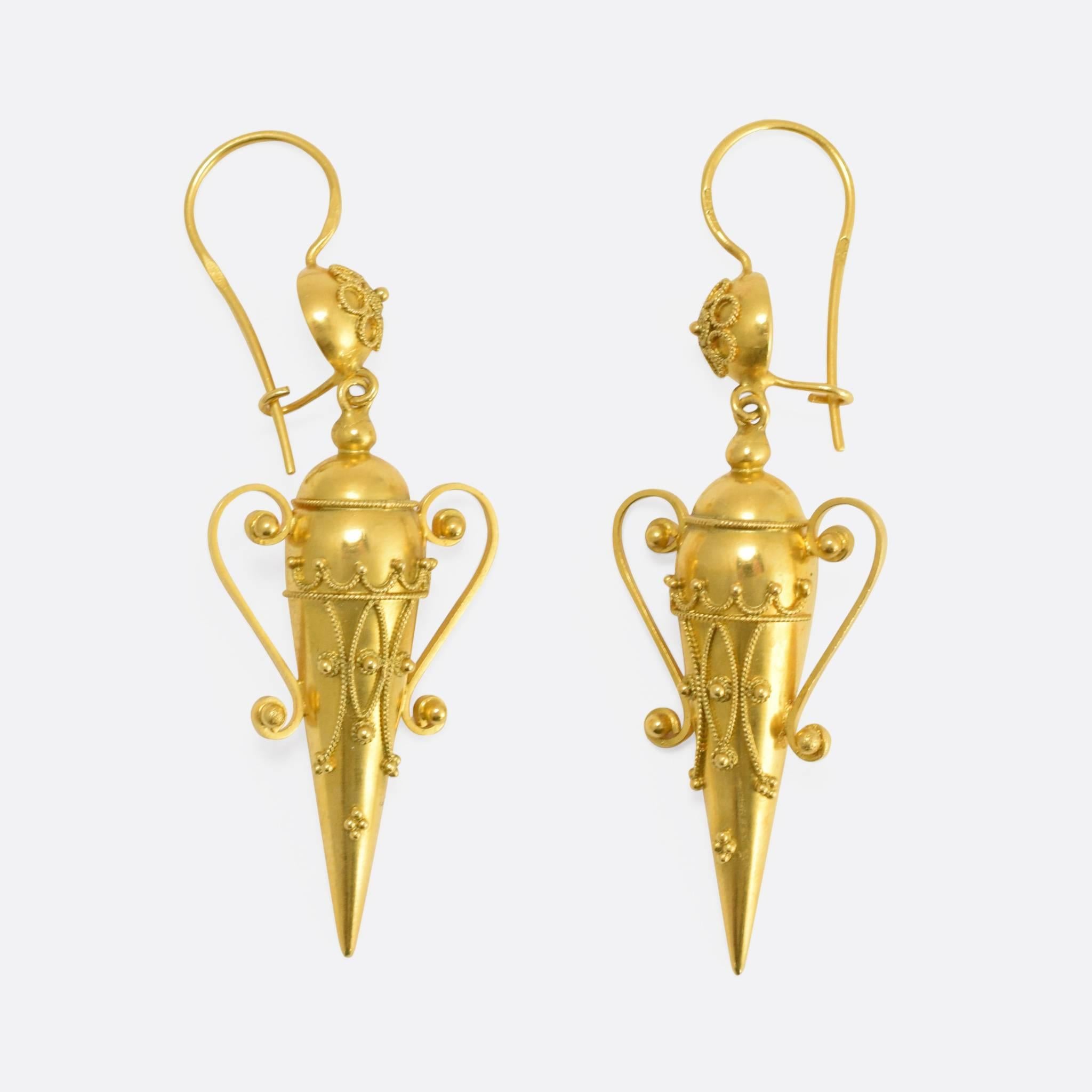 These exceptional antique earrings have been fashioned as amphorae, the (usually) ceramic vessels used by the ancients to transport wine, oil, and other liquid commodities. The earrings are in the Etruscan Revival style with applied rope and beaded