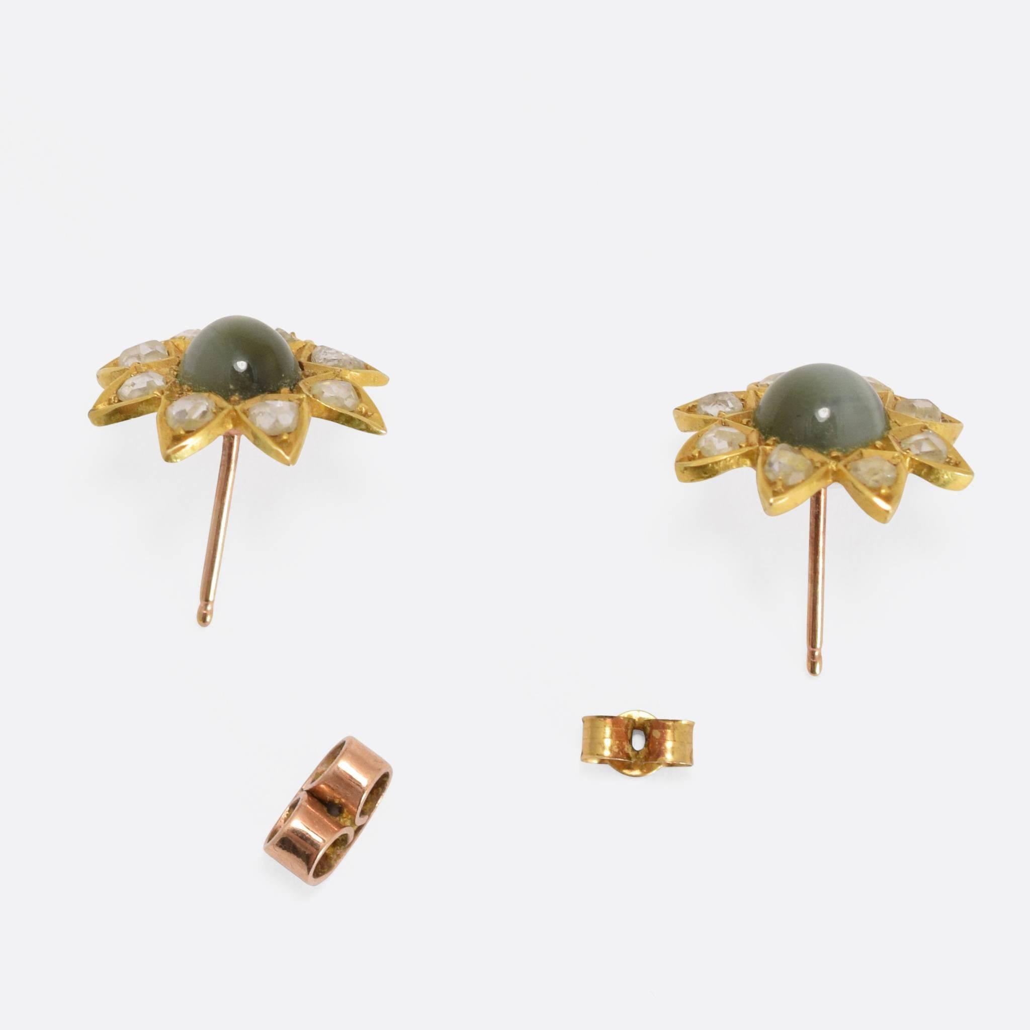 This fabulous pair of antique flower cluster studs have been converted (quite some time ago) into earrings. They will have been studs or buttons originally, set with Cat's Eye chrysoberyl and rose cut diamonds, but we think that their current