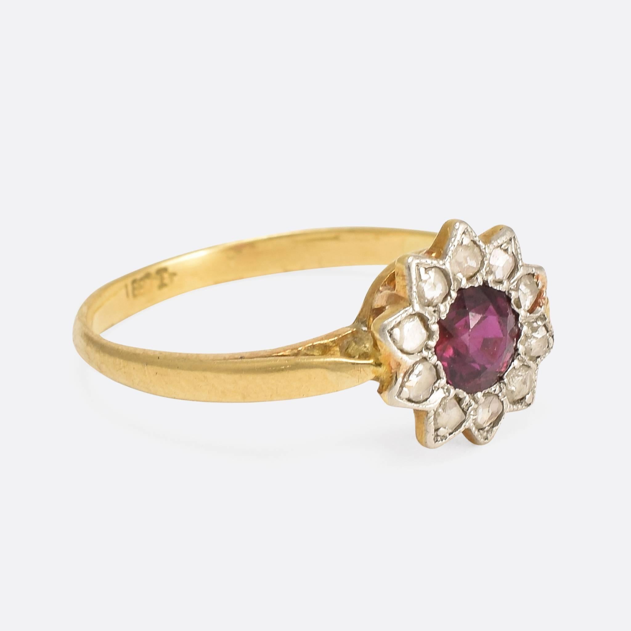 This adorable antique flower ring pretty and striking at the same time, with unusual pointed (sunflower-esque) petals and a fabulous central ruby, of exceptional colour. The head is finished in millegrain platinum, and the band modelled in rich 18ct