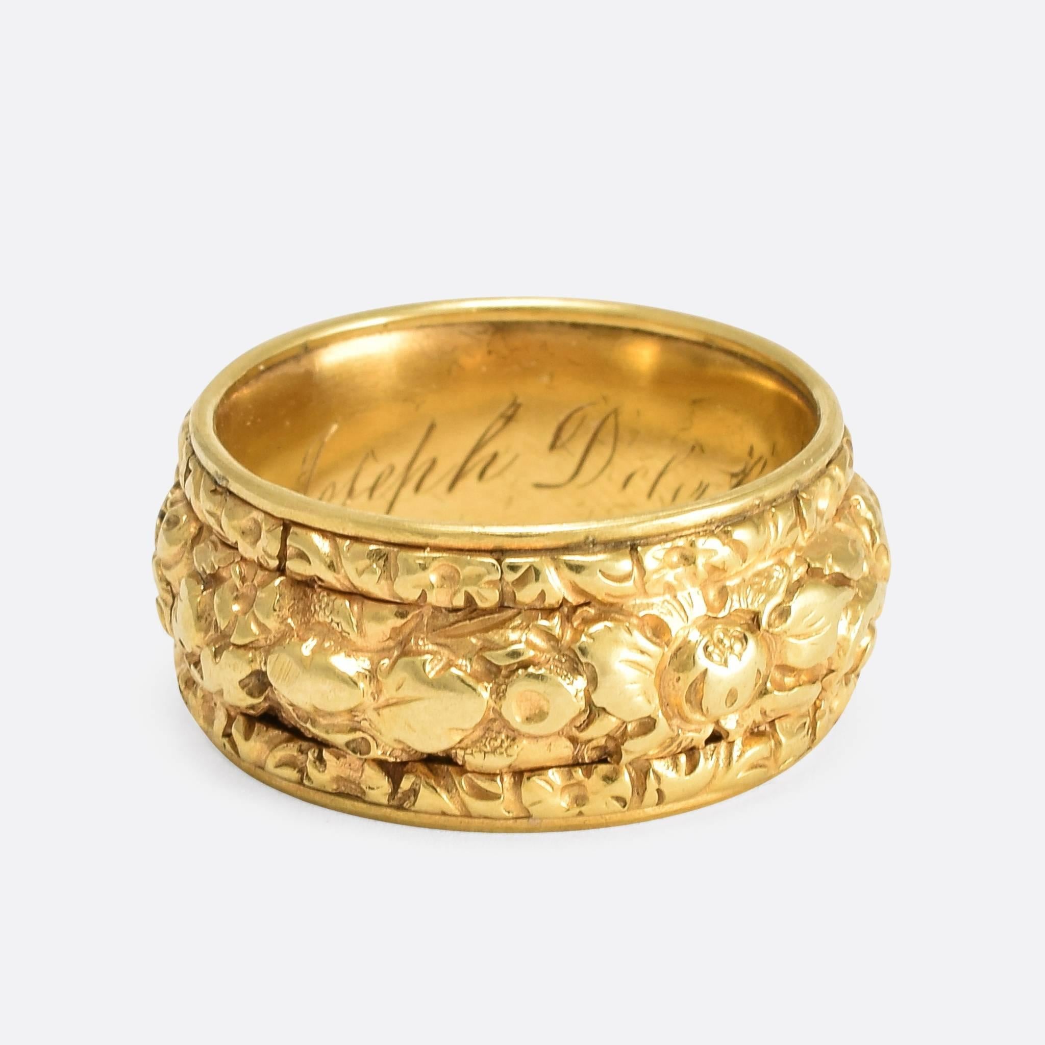 This glorious 19th Century memorial ring features deeply chased detail to the outer band, with flowers, foliage, and shell motifs. An inscription inside reads: 