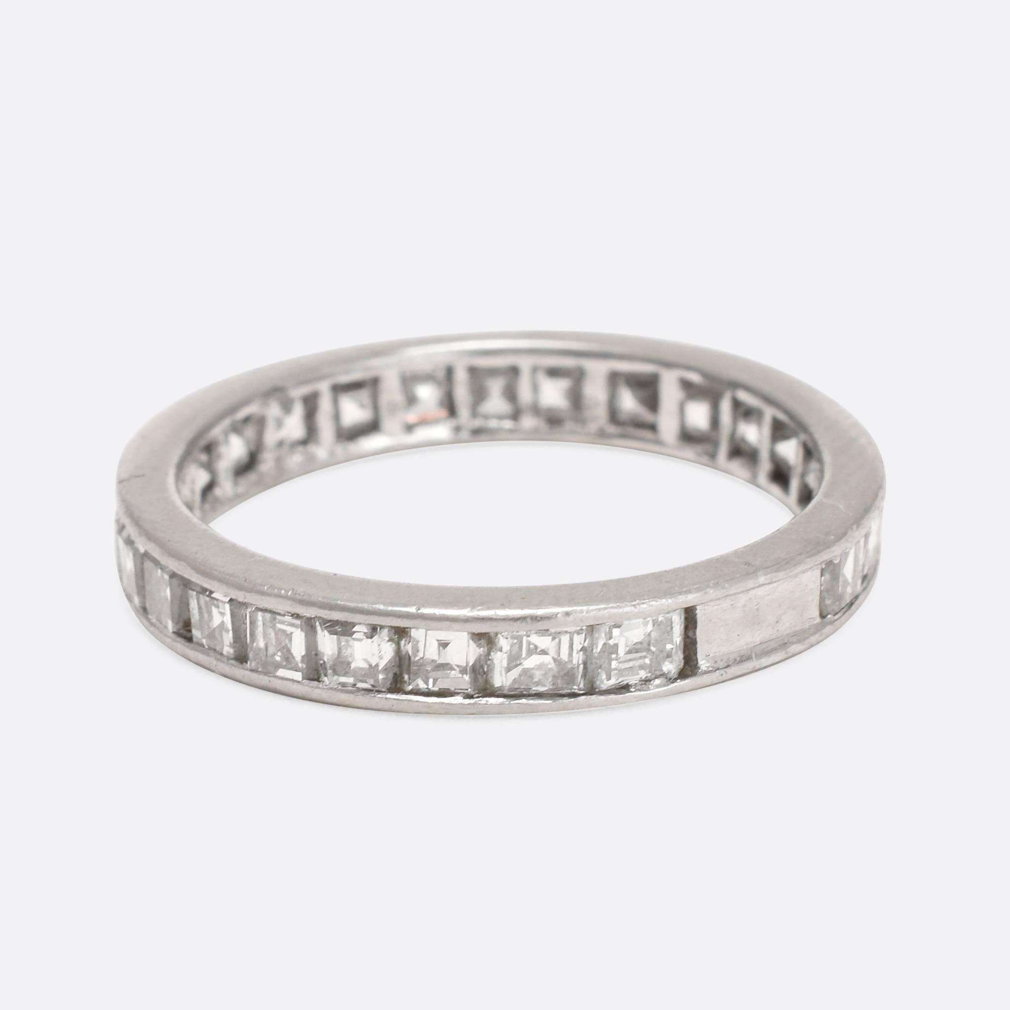 This exceptional vintage eternity ring is fully set with 25 carre cut diamonds, the weight totalling 2 carats. The ring is modelled in platinum throughout, and the deep stones are particularly clean and bright. An refined and timeless ring, unusual