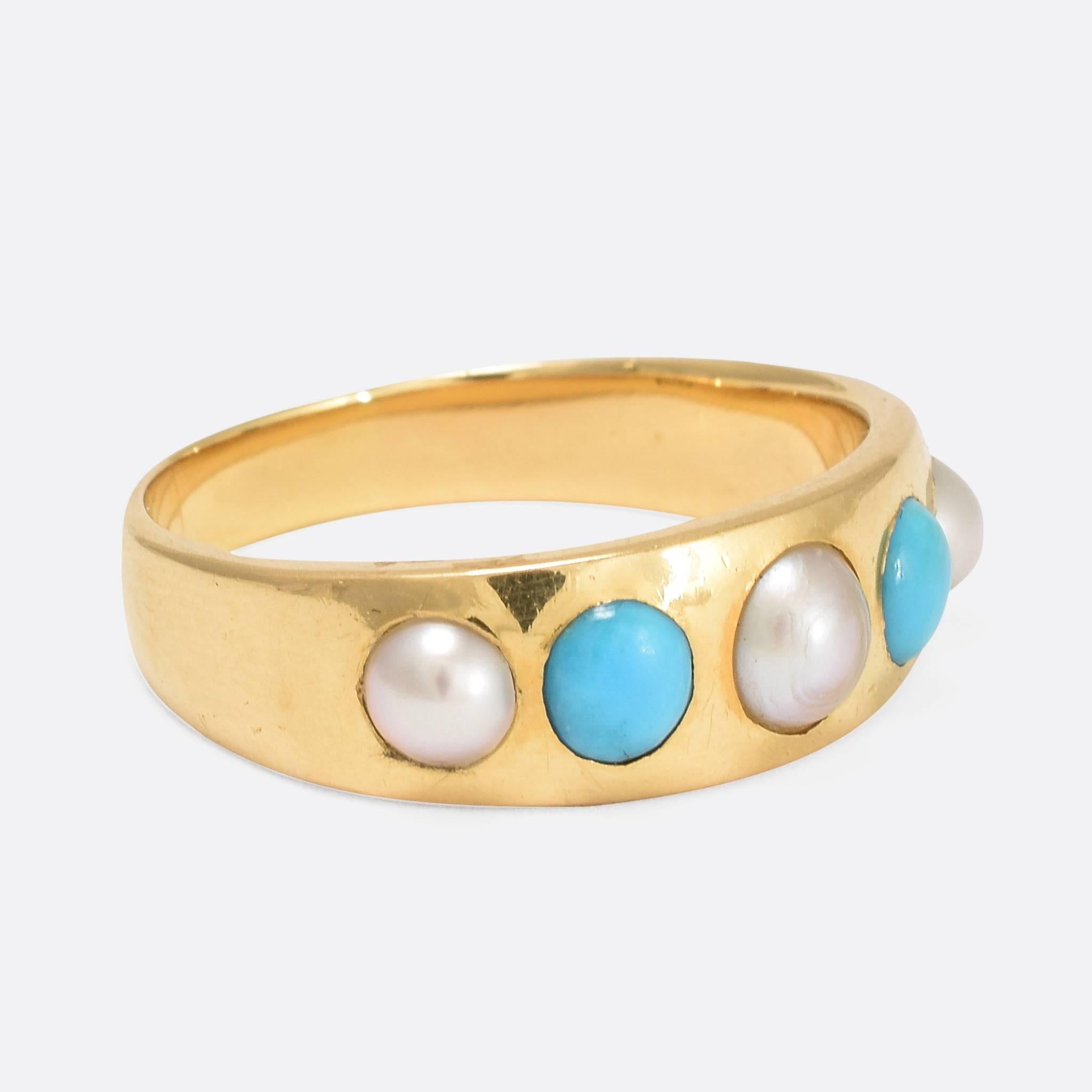 This attractive antique gypsy ring is set with five stones: three natural pearls and two turquoise cabochons. Modelled in 18ct gold, it dates to c.1880. They gypsy ring was a popular style throughout the Victorian era, characterised by a tapered