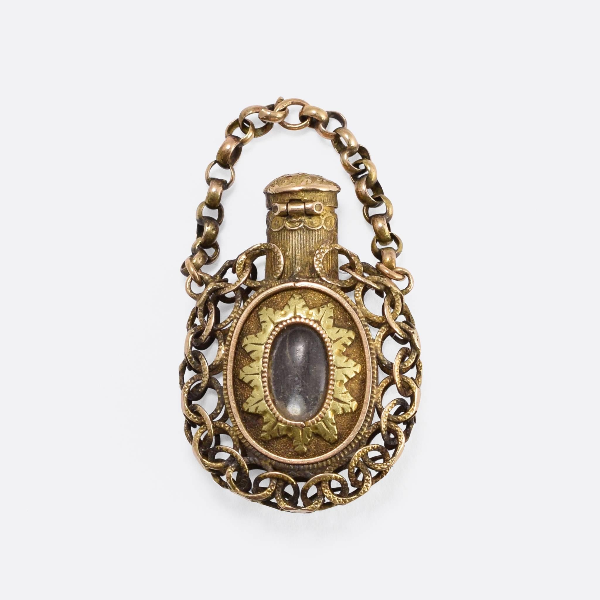 A wonderful Georgian period scent bottle, on one side is set a shell cameo of a cherub with flute, and on the other a locket compartment with an applied two-tone gold foliate surround. With a hinged top and superb chain-link goldwork around the
