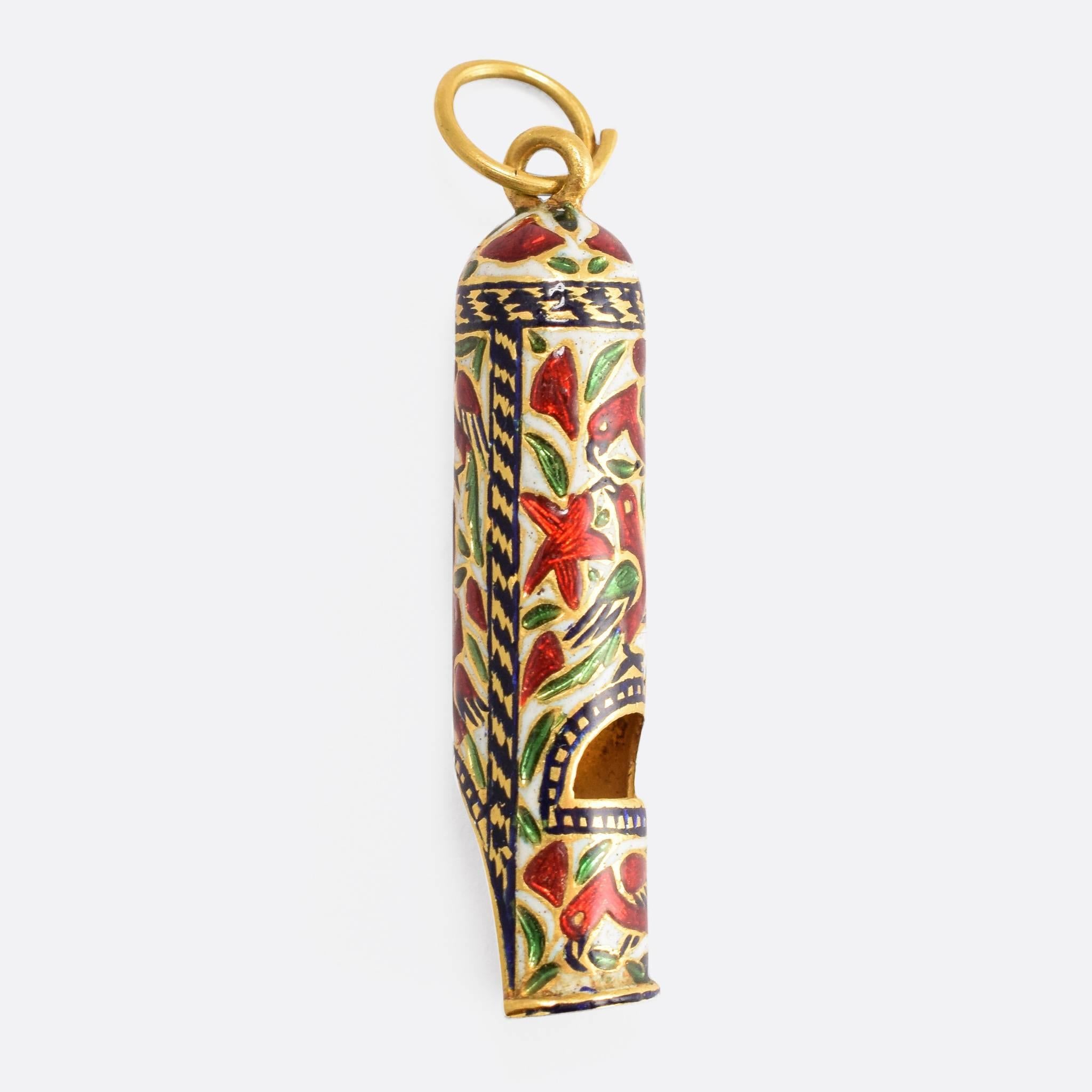 This fantastic antique whistle pendant is adorned with vibrant enamel work in the Mughal style. The motifs include birds, star-shaped flowers, and intricate foliate patterns, all finished in the brightest colours on a base of pure white. It's