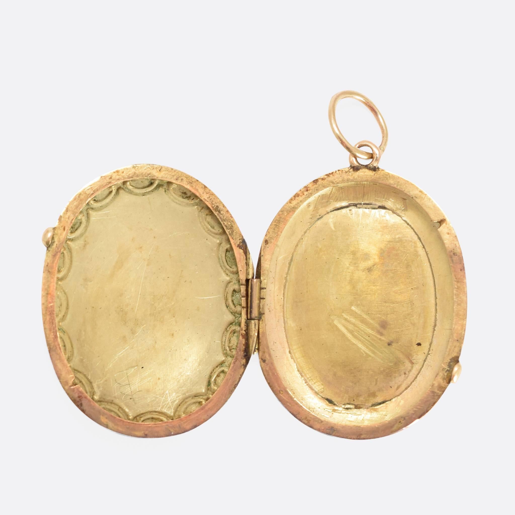 This exquisite early Victorian locket is modelled in 14ct gold, and finished with a charming enamelled portrait. The lady depicted is wearing a vivid red dress, with matching head-wear set with four (real!) rose cut diamonds. She also wears flowers