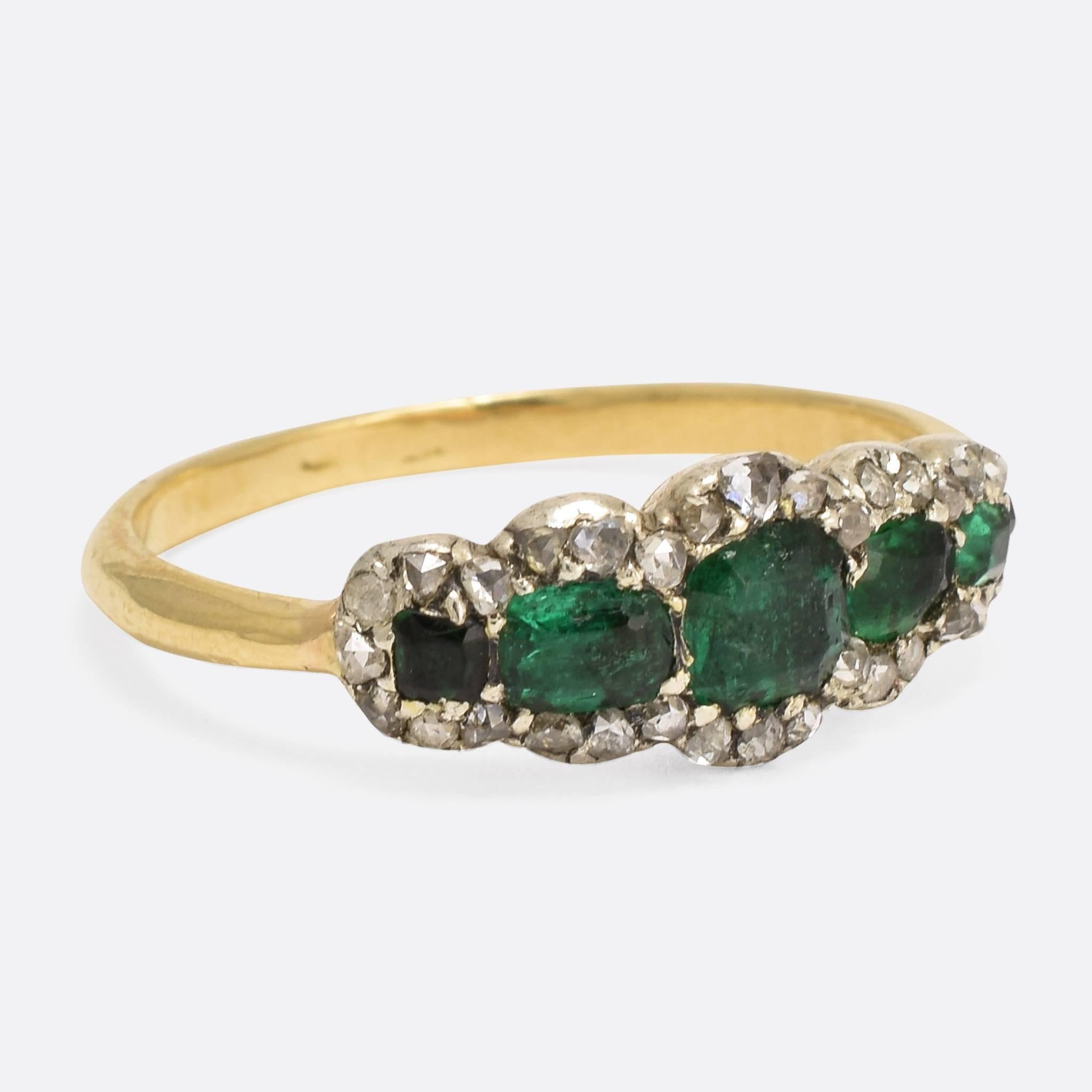 This superb Georgian ring is set with five striking emeralds, set within a cluster of rose cut diamonds - all resting in closed backed settings. It dates to c.1830, modelled in 15ct gold and silver. An exceptionally stylish early 19th Century Ring.