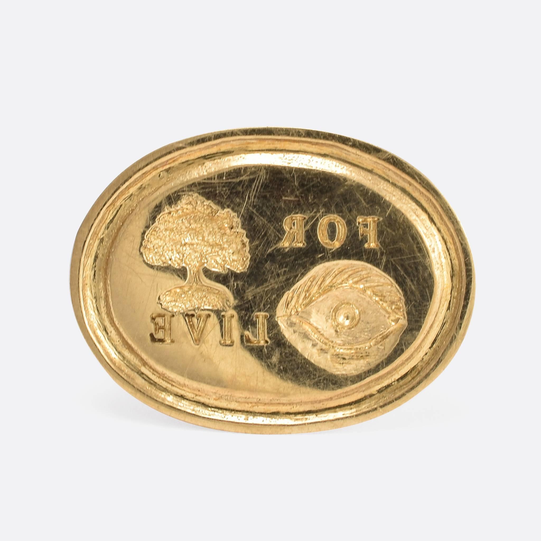 This gold signet ring features a hand carved intaglio rebus puzzle. Popular in the Georgian era, the rebus puzzle uses pictures, symbols or letters to phonetically 