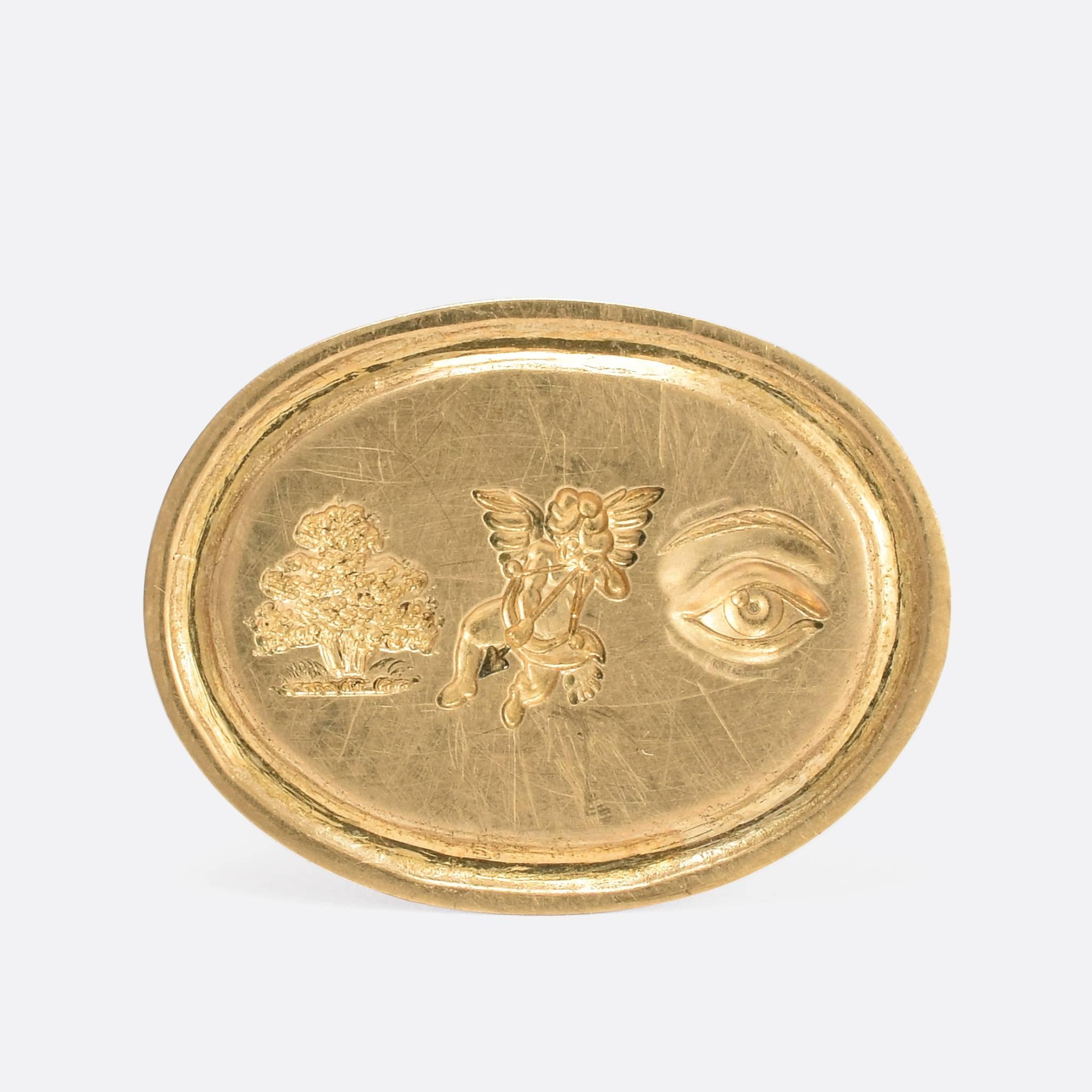 This gold signet ring features a hand carved intaglio rebus puzzle. Popular in the Georgian era, the rebus puzzle typically uses pictures, symbols or letters to phonetically 