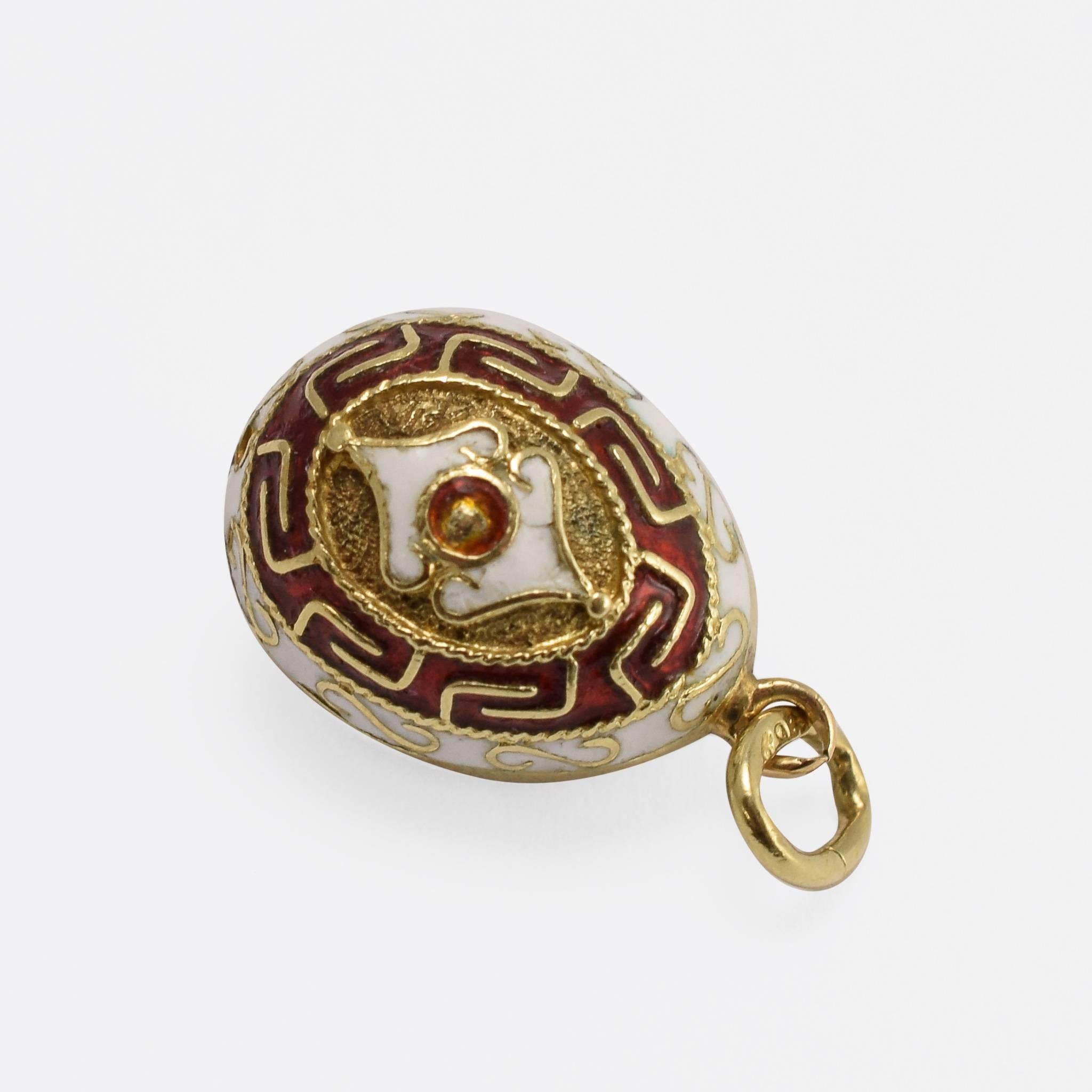 This charming Russian miniature egg pendant dates to the late 1930s. Finished in fine enamel, the designs include swirls, ropework and labyrinth-style embellishment - all in a beautiful crimson and white. An wonderful example of stunning Russian