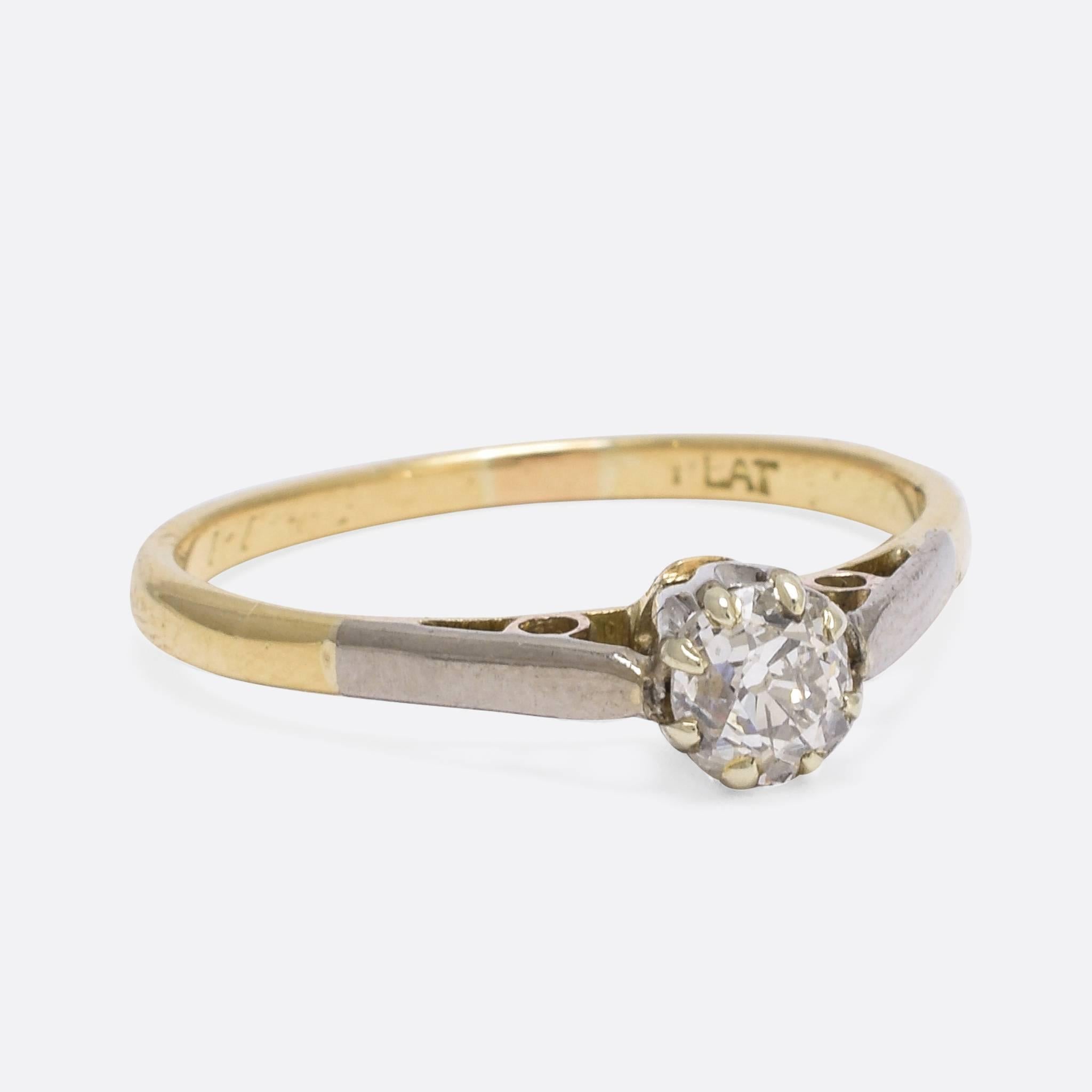 This stylish antique solitaire engagement ring is set with a beautiful .48ct cushion cut diamond. The classic 8-claw mount is modelled in 18ct gold, with platinum settings and a platinum finish that runs down the shoulders to create a lovely