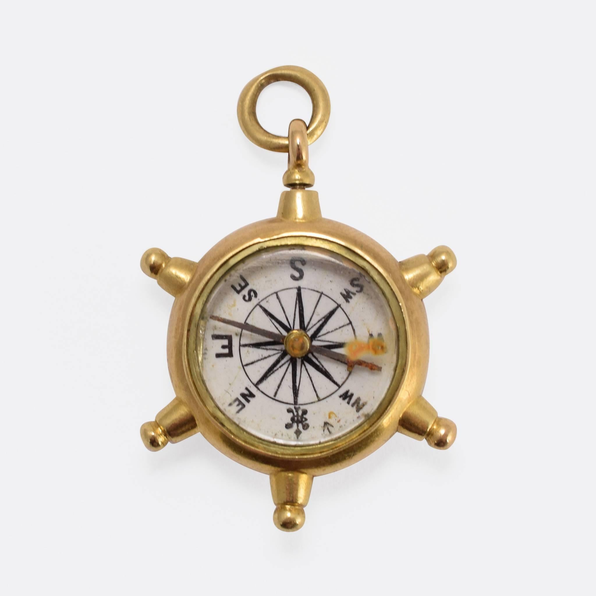 This exceptional antique Ship's Wheel pendant features a working compass on one side, and a 