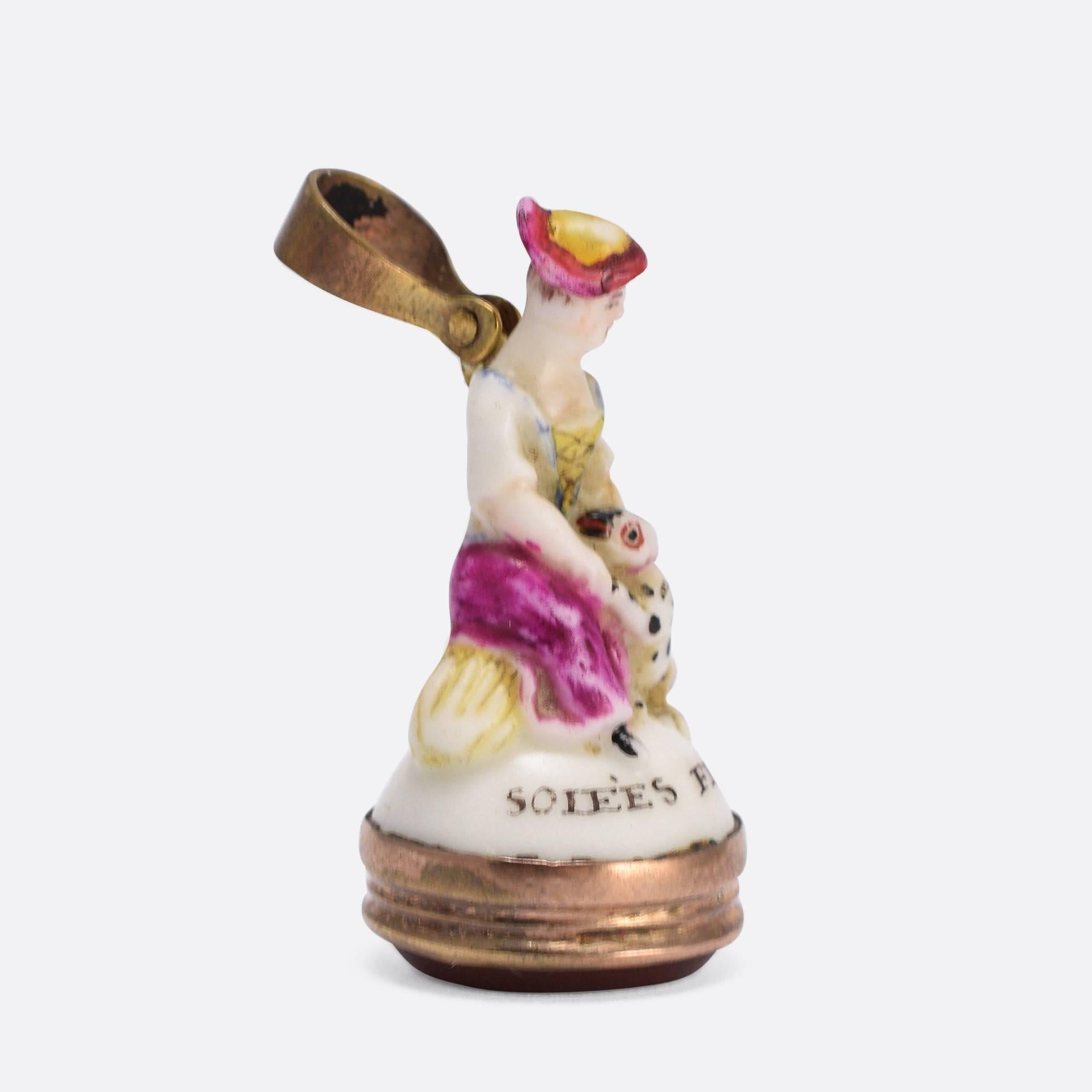 An original 18th Century porcelain Derby Chelsea period fob seal. This particular piece features a lady and a Dalmatian puppy, and displays the vivid colouring typical of the Derby factory. The design is older, however, originating from the earlier