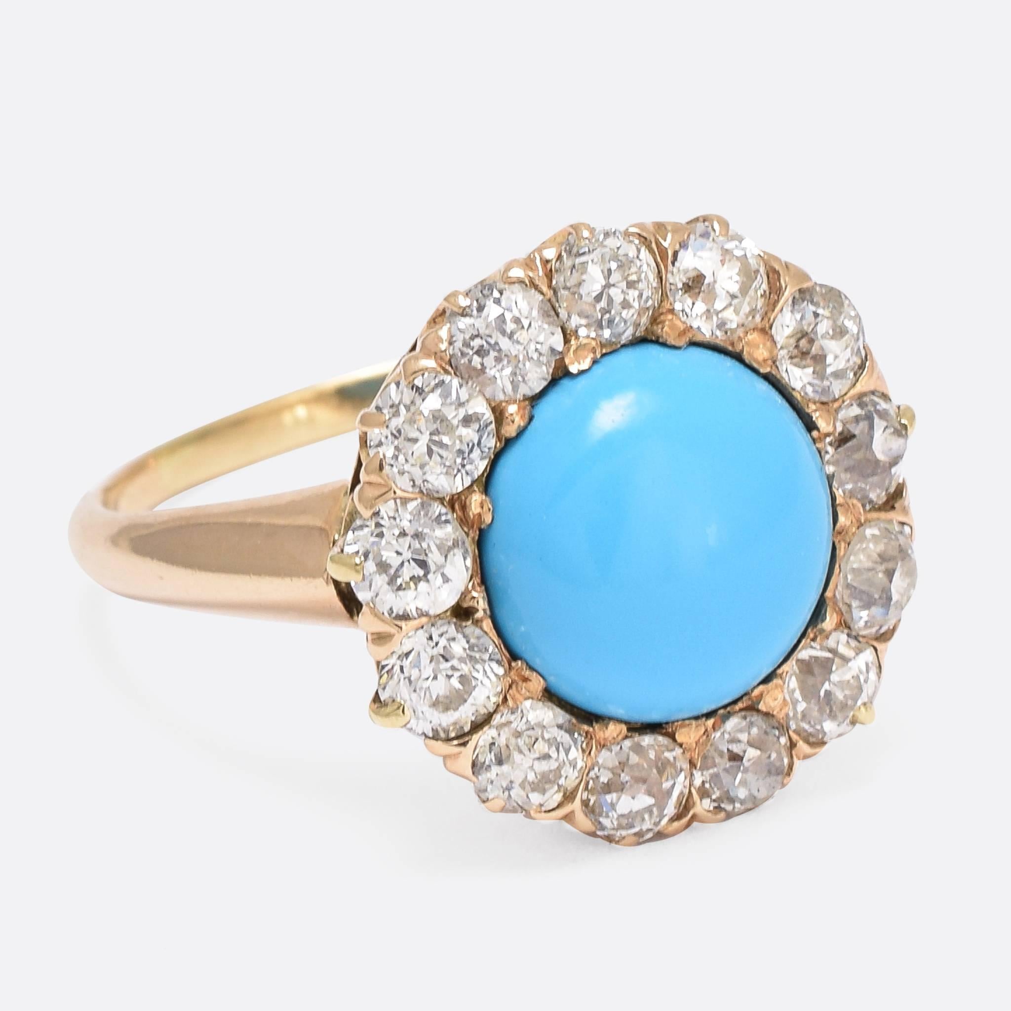 This superb antique round cluster ring is set with a principal Persian turquoise cabochon, surrounded by a halo of old cut diamonds. The piece dates to the late 19th Century, exceptionally well proportioned, with bright diamonds and a vivid