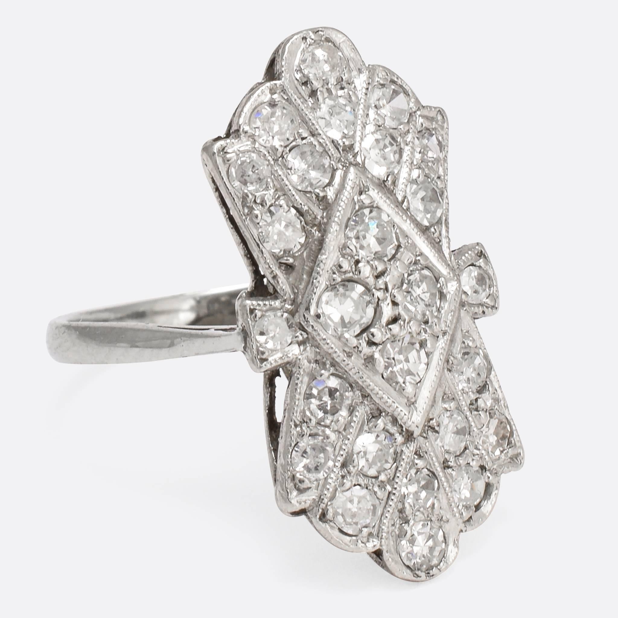 This cool Art Deco period cluster ring is modelled in 18k white gold, with platinum settings. The head is home to around .68ctw of super sparkly eight-cut diamonds that flash wildly in the light, and finished with fine millegrain detail. The styling