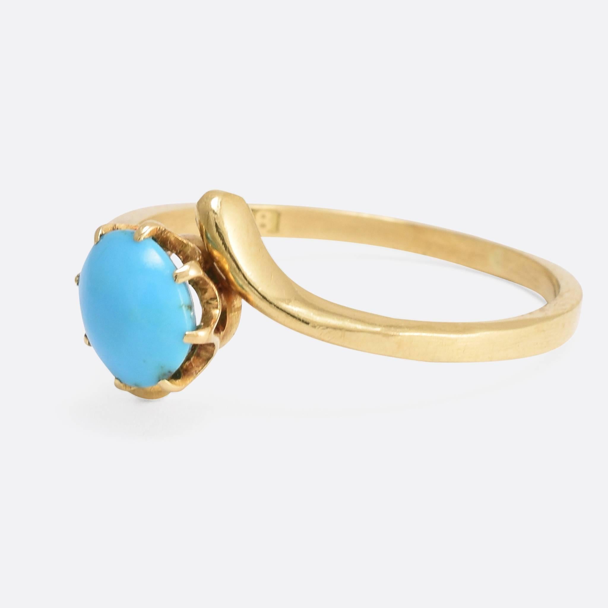 A sweet antique turquoise single-stone ring, with graceful crossover shoulders very much in the Art Nouveau style. It's modelled in 18k yellow gold, and dates to the turn of the century - c.1900. The oval cabochon stone is a great colour, set in a